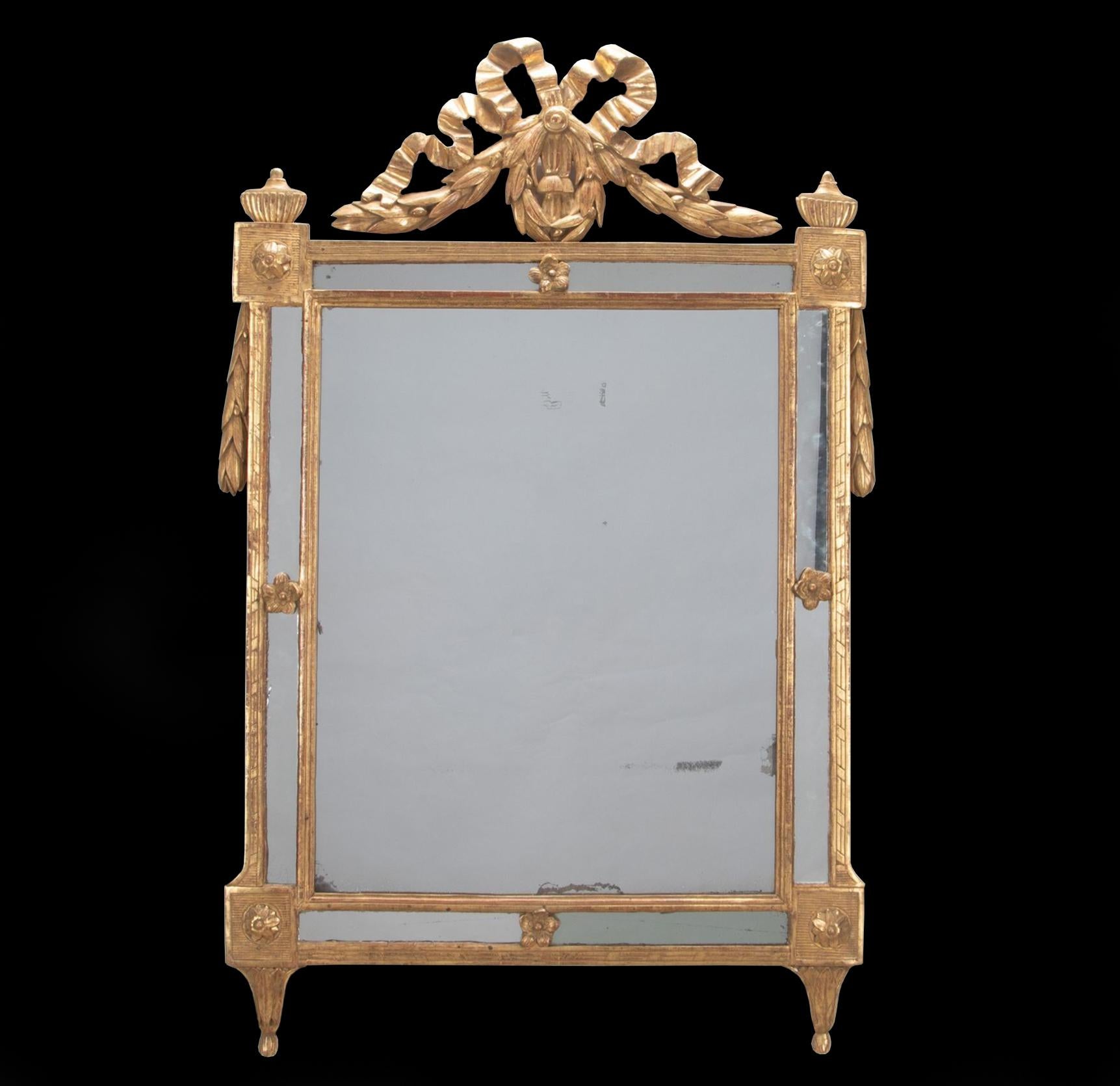 A fine French Louis XVI period late C18th/ early C19th gilded mirror. 

The original rectangular mercury plate surrounded with further mirrored borders. The giltwood cresting boldly carved with a large flowing tied ribbon, trailing husk and berry