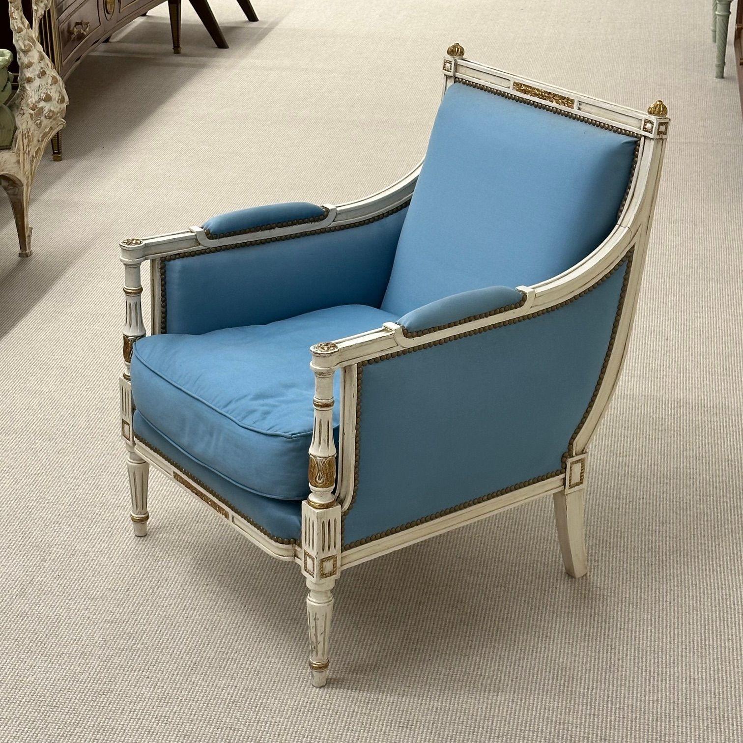 Louis XVI, French Arm Chair or Bergère, Painted Wood, Giltwood, Baby Blue Fabric, 1950s

A charming Louis XVI style paint decorated bergère. The frame features antique white painted wood and giltwood accents. Later soft baby blue upholstery. The
