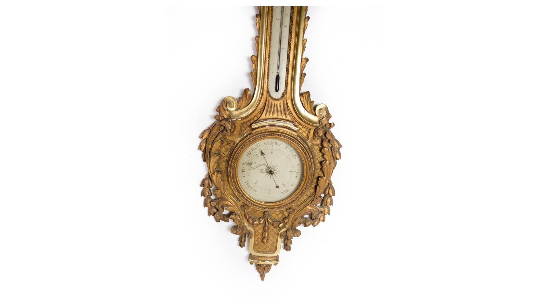 A Louis XVI French barometer adorned with intricate carvings and original gilding, dating back to the late 1700s. This exquisite piece stands as a testament to the opulence and craftsmanship of the period, showcasing unparalleled beauty and