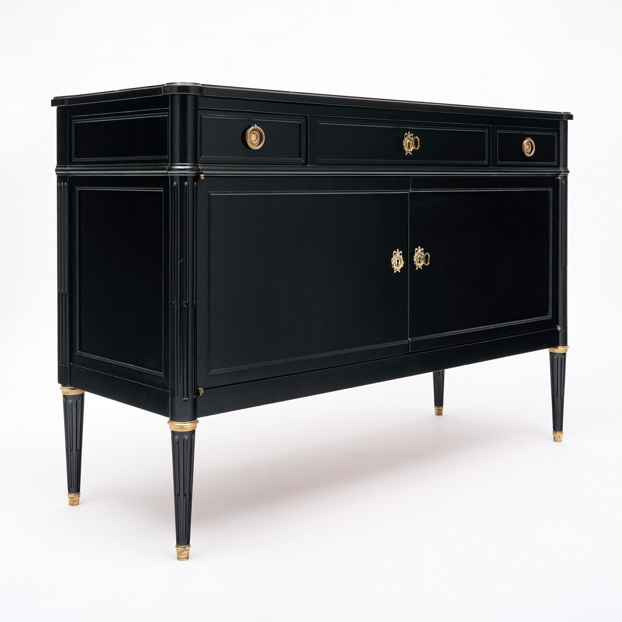 Buffet from France in the Louis XVI style. This piece is made of solid wood construction, primarily mahogany. It has been ebonized and finished with a lustrous French polish of museum-quality. There are Three molded and dovetailed drawers above two