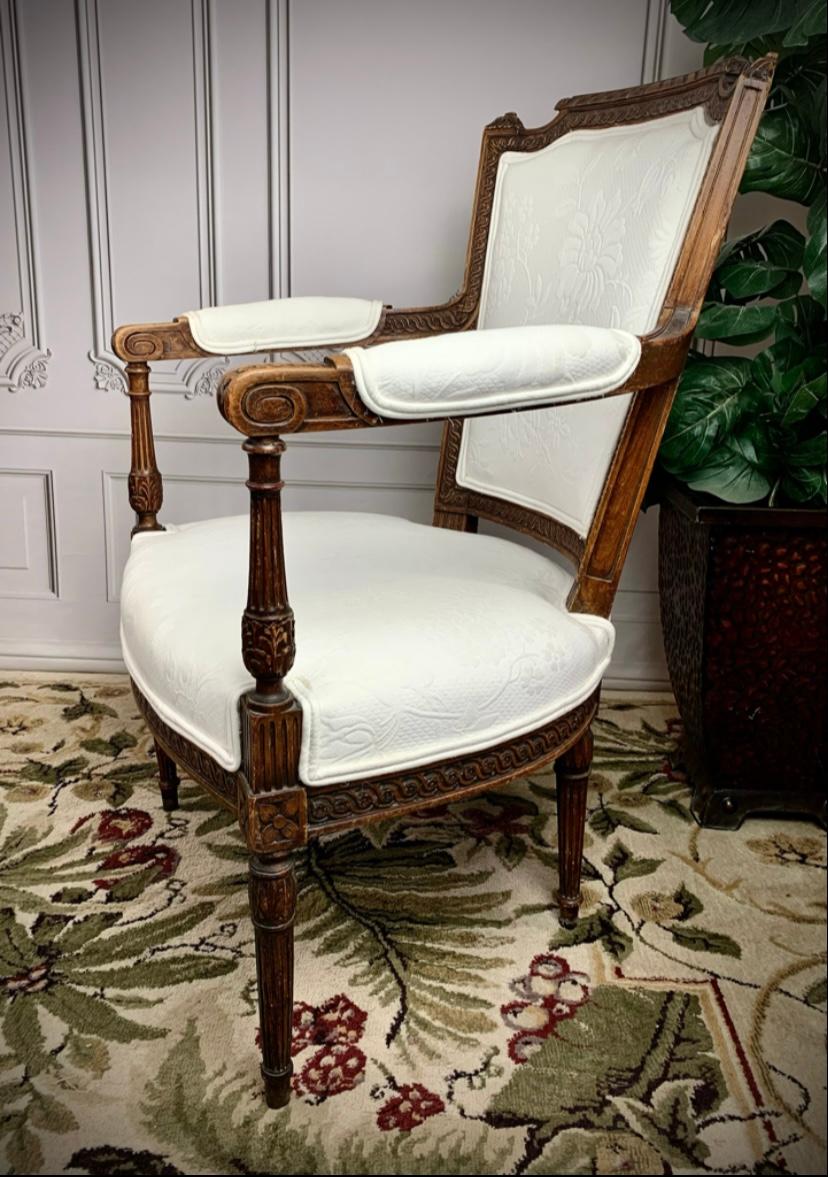Incorporate a hint of French provincial style and class. Original solid wood frame artisan crafted with rich, sturdy walnut. Professionally reupholstered in a clean, crisp white damask fabric. Exquisitely hand-carved detail showcasing traditional