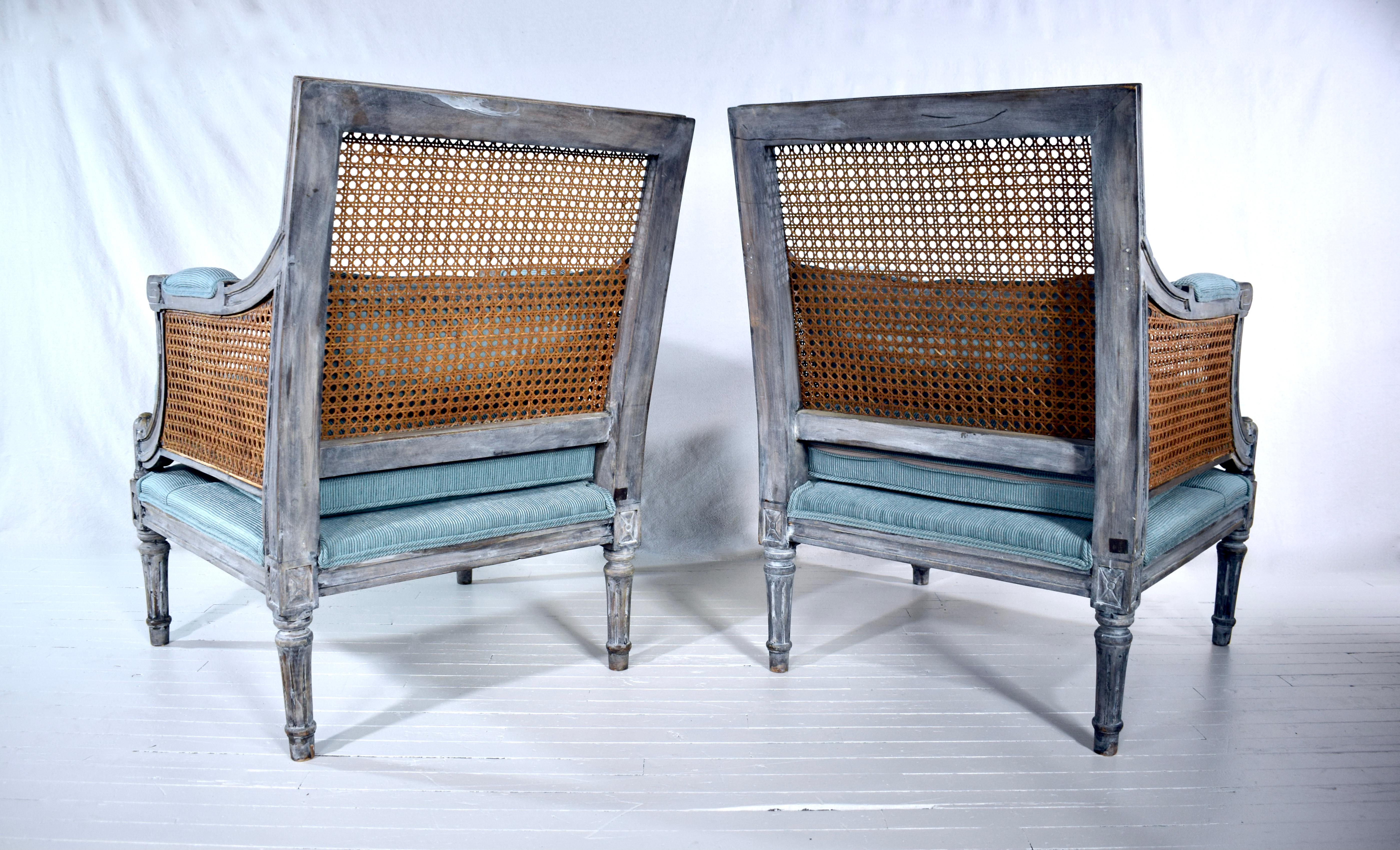 20th Century Louis XVI French Style Painted Bergere Chairs, a Pair