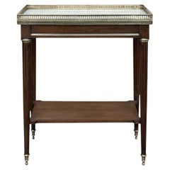 Louis XVI Gallery Table in solid mahogany with a refined marble top, pierced bra