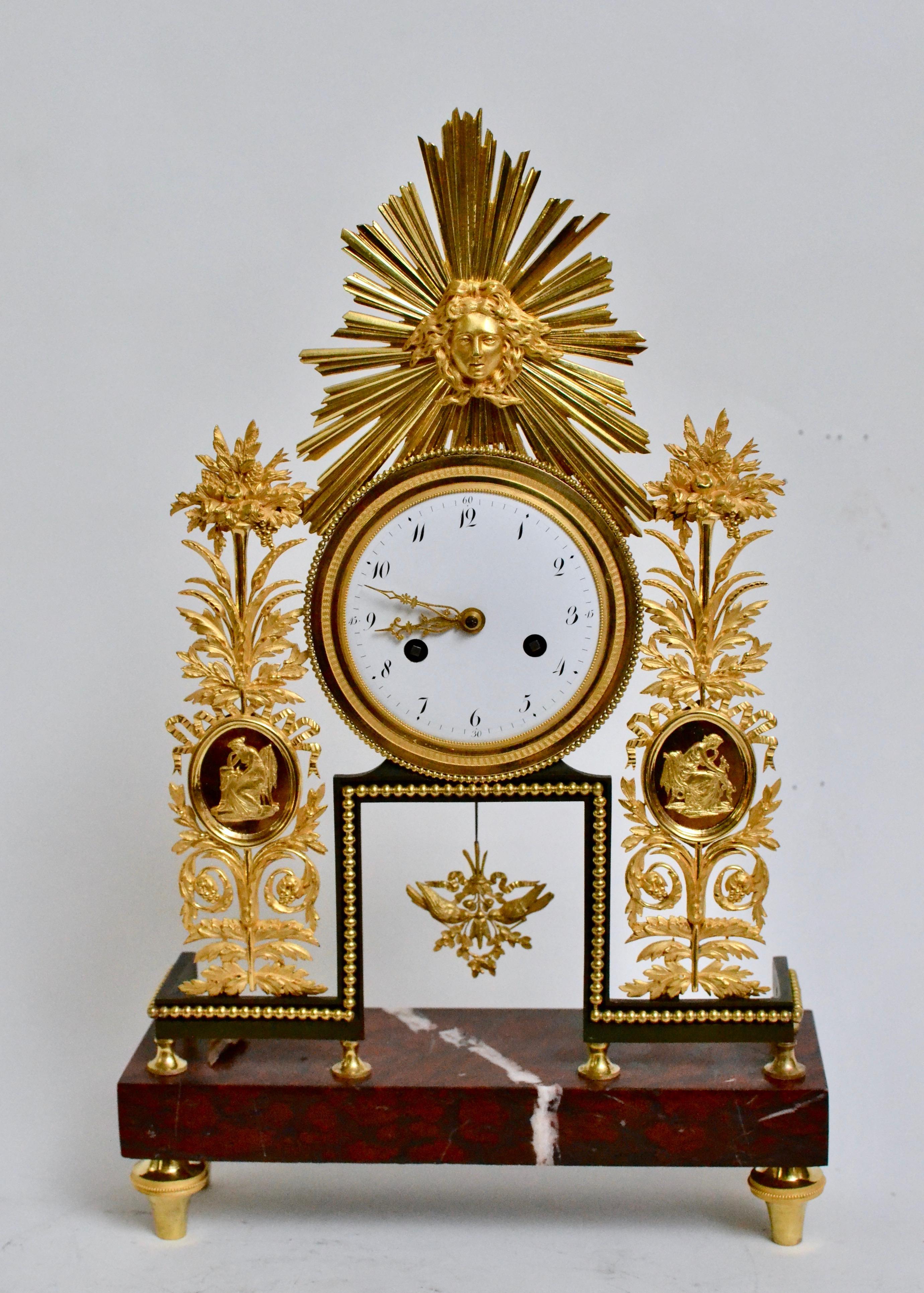 A Louis XVI gilt bronze and marble mantel clock.