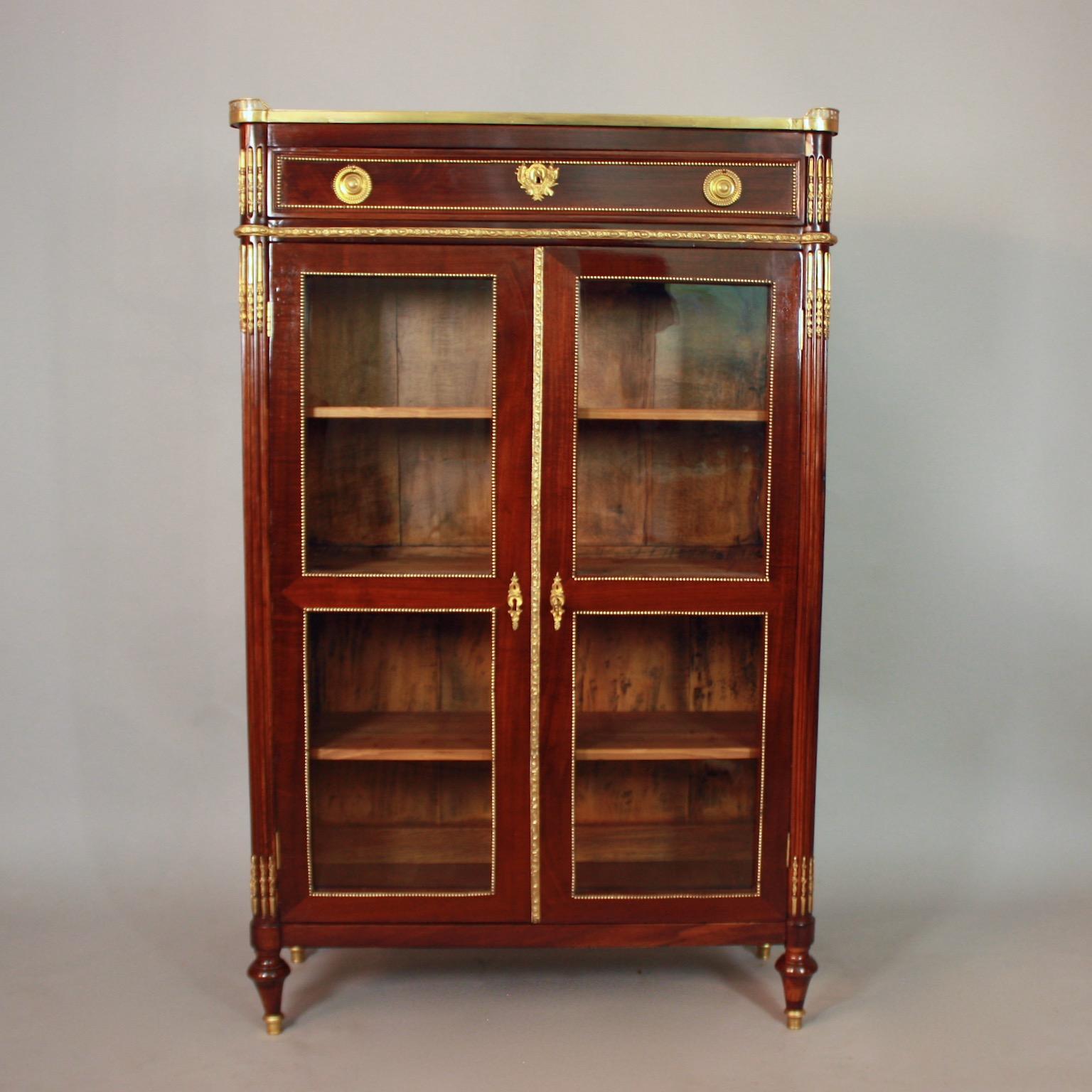 French 18th Century Louis XVI Mahogany Gilt Bronze Vitrine/Showcase or Bibliotheque

A late 18th century gilt-bronze mounted vitrine or bibliotheque of the late 18th century. The marble top with outset rounded corners enclosed by a pierced gallery