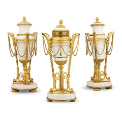 Louis XVI Gilt Marble Cassolettes And Clock