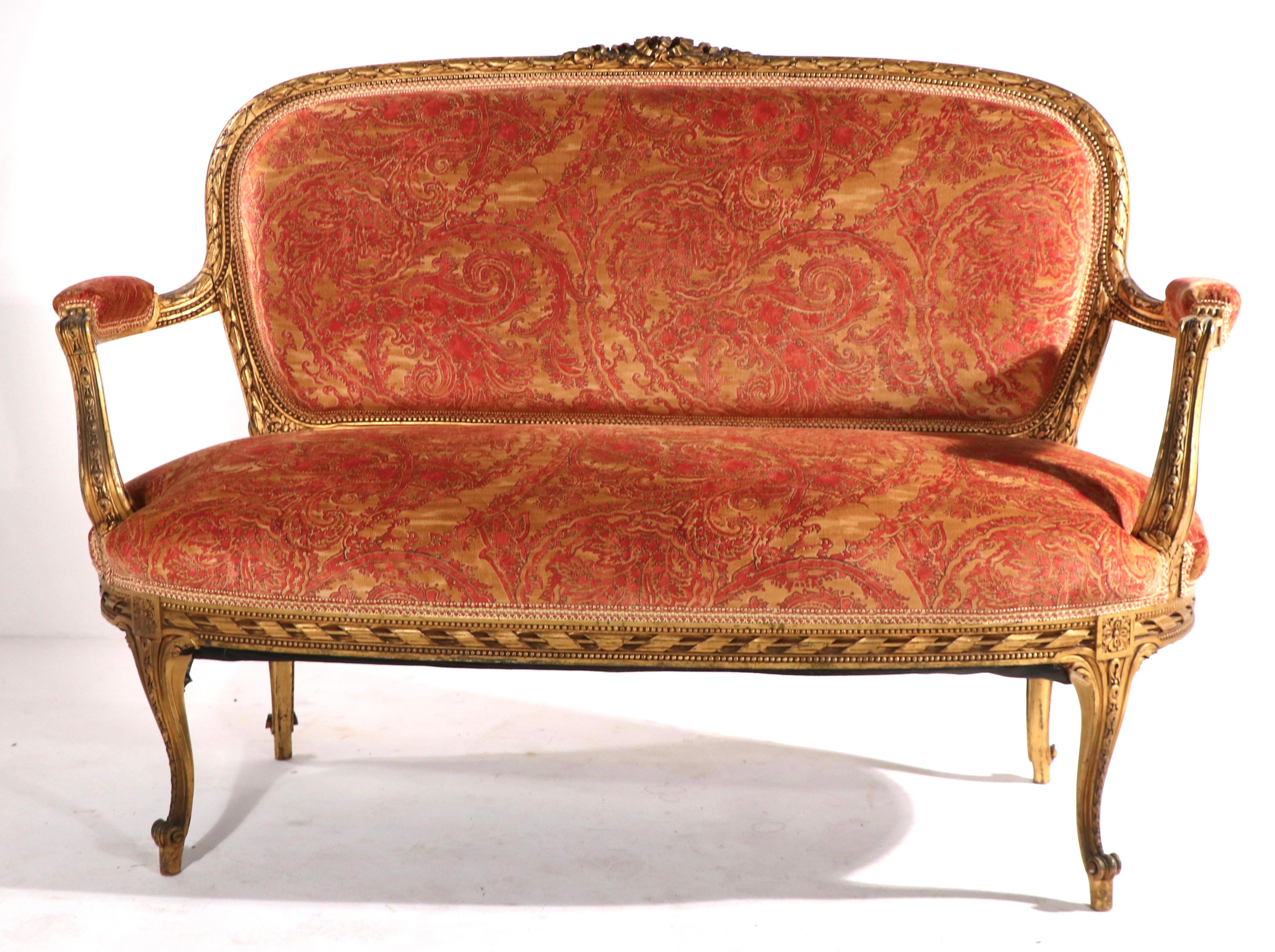 Exceptional gilt settee with Fortuny fabric upholstery. We believe the frame is period Louis XVI, but we are not experts in this period. This example is in excellent condition, clean and ready to use. Elegant, sophisticated and chic - top quality