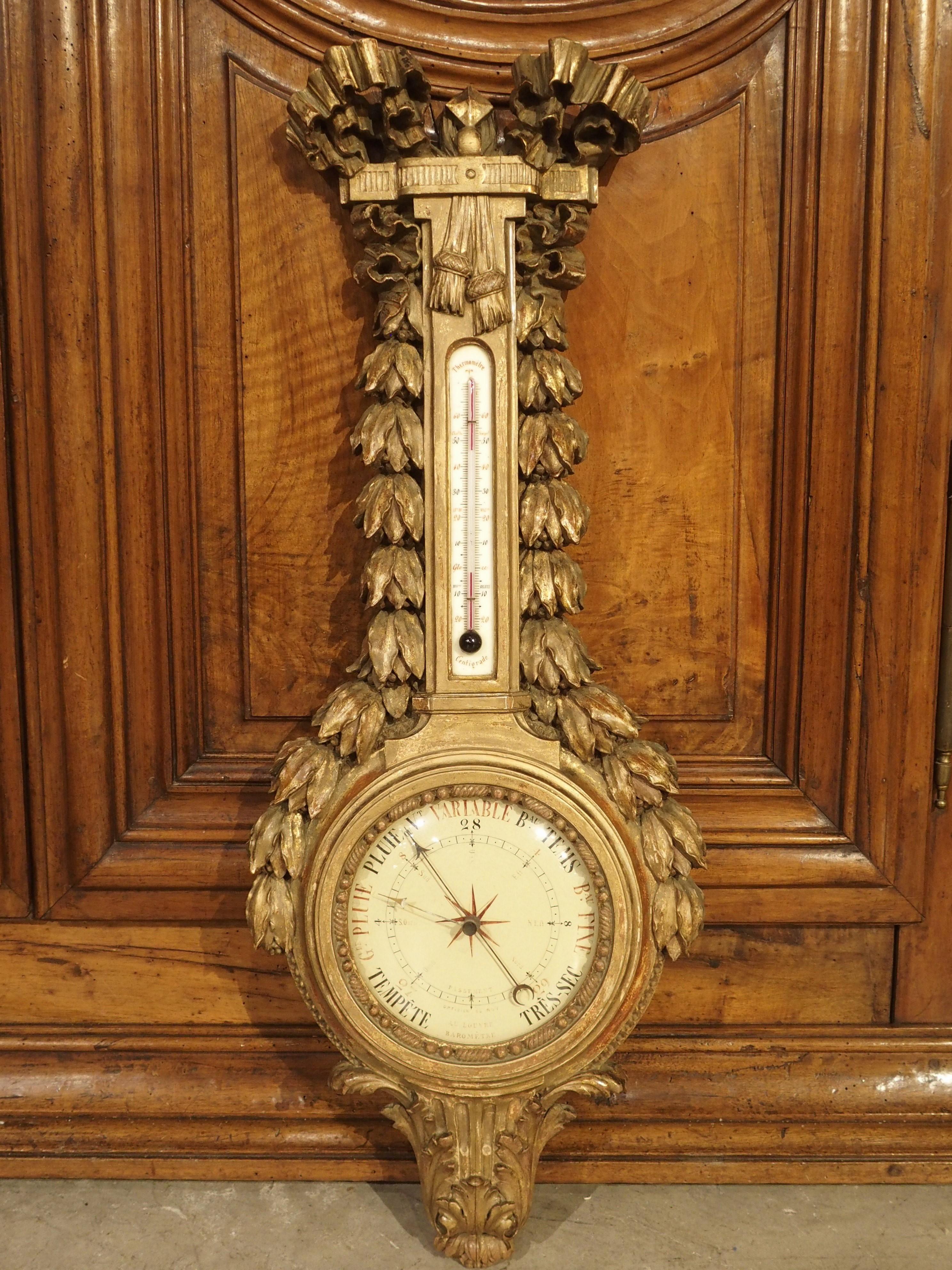 This well-carved French aneroid barometer and thermometer is from the late 1700’s. The gilded scientific instrument is a beautiful example of a period Louis XVI piece.

The top of the apparatus is adorned with a large crinkled ribbon. A repeating