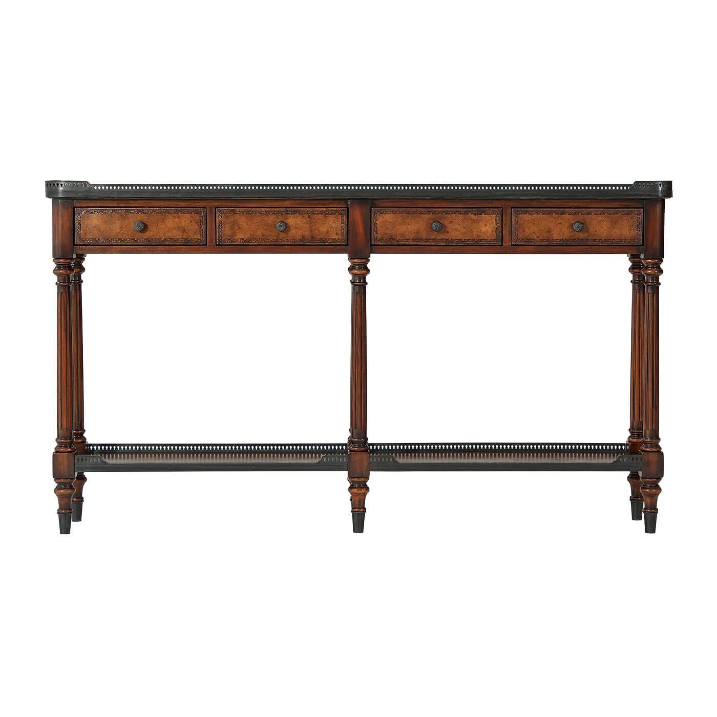 A Louis XVI style narrow leather paneled and solid wood console table, decorated throughout with verdigris brass mounts, the galleried top above four frieze drawers on turned and fluted legs joined by a brass galleried under tier. 

Dimensions: