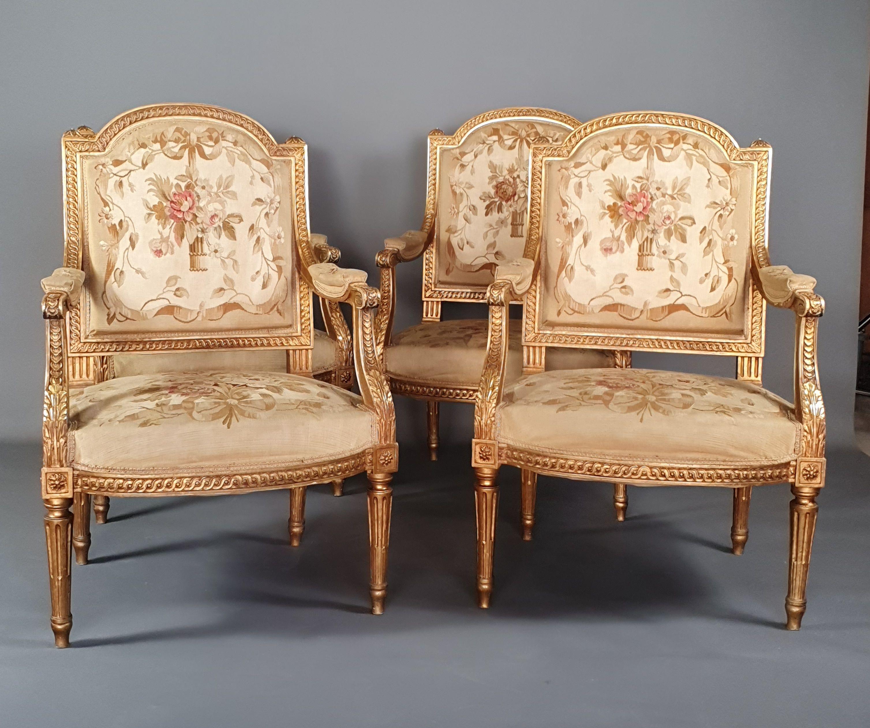 Louis XVI living room furniture in gilded wood richly carved with interlacing friezes and acanthus leaves, rudent fluted legs. Superb Abusson tapestry upholstery decorated with flower baskets and floral compositions in an entourage of branches and