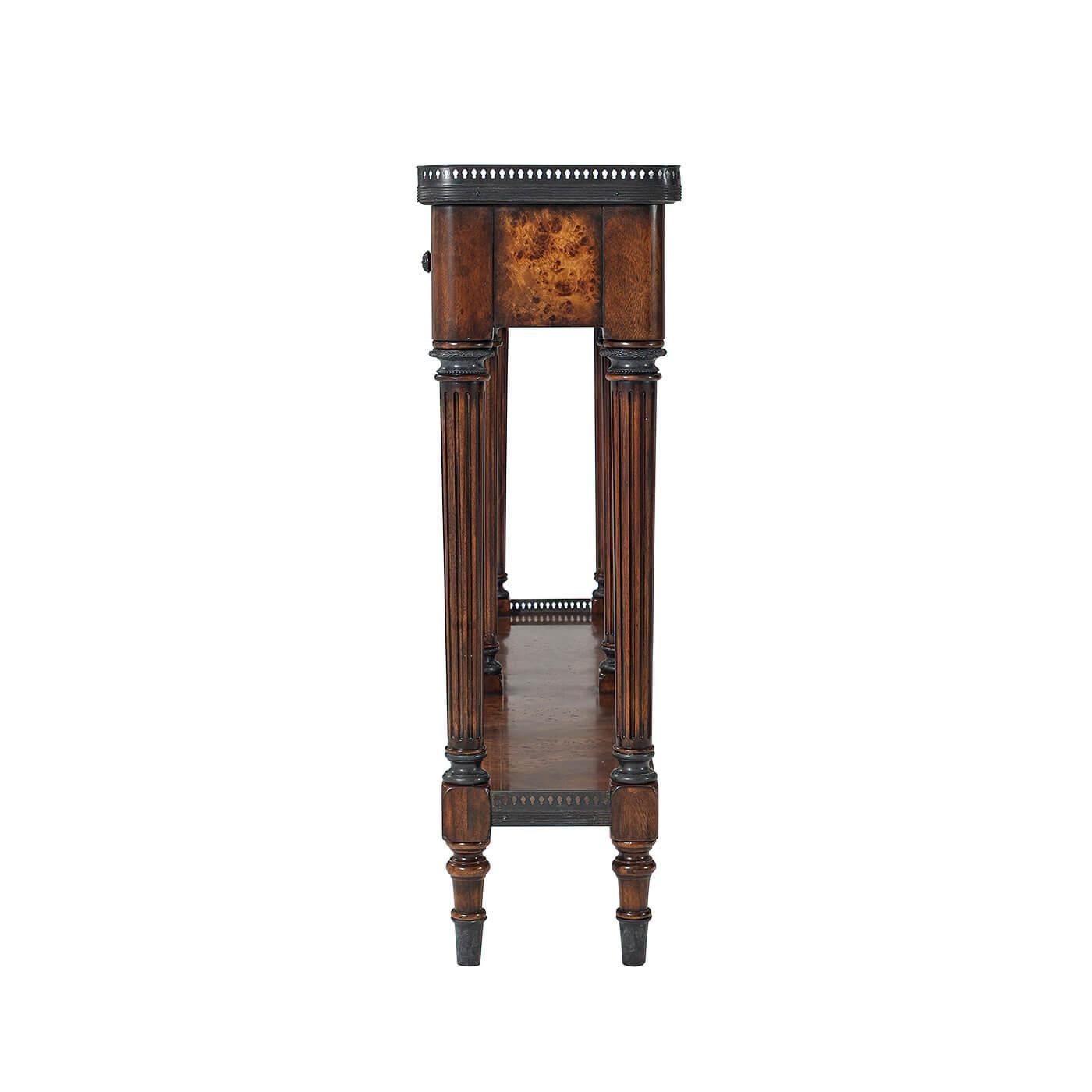 A Louis XVI style long narrow burl veneer and acacia console table. The rectangular top with rounded corners and a brass gallery, above four frieze drawers, supported on six turned and fluted legs joined by a galleried under tier, on block and