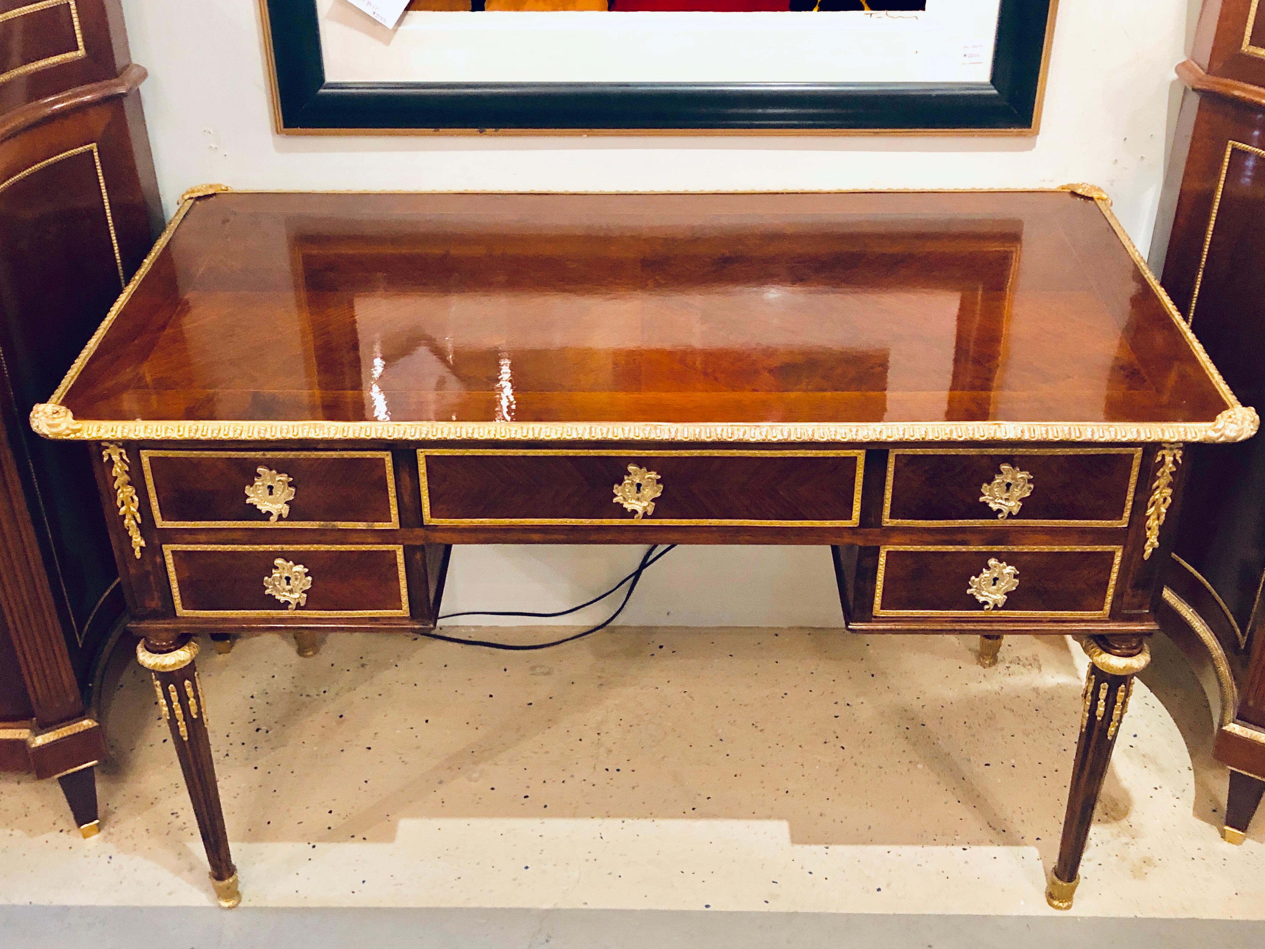 A Spectacular Fully Refurbished Louis XVI Maison Jansen Style Bronze Mounted Writing Desk or Bureau Plat / Vanity. The case is Finished on All Sides and can easily sit center room in any home or office and is certain to demand attention. This finely