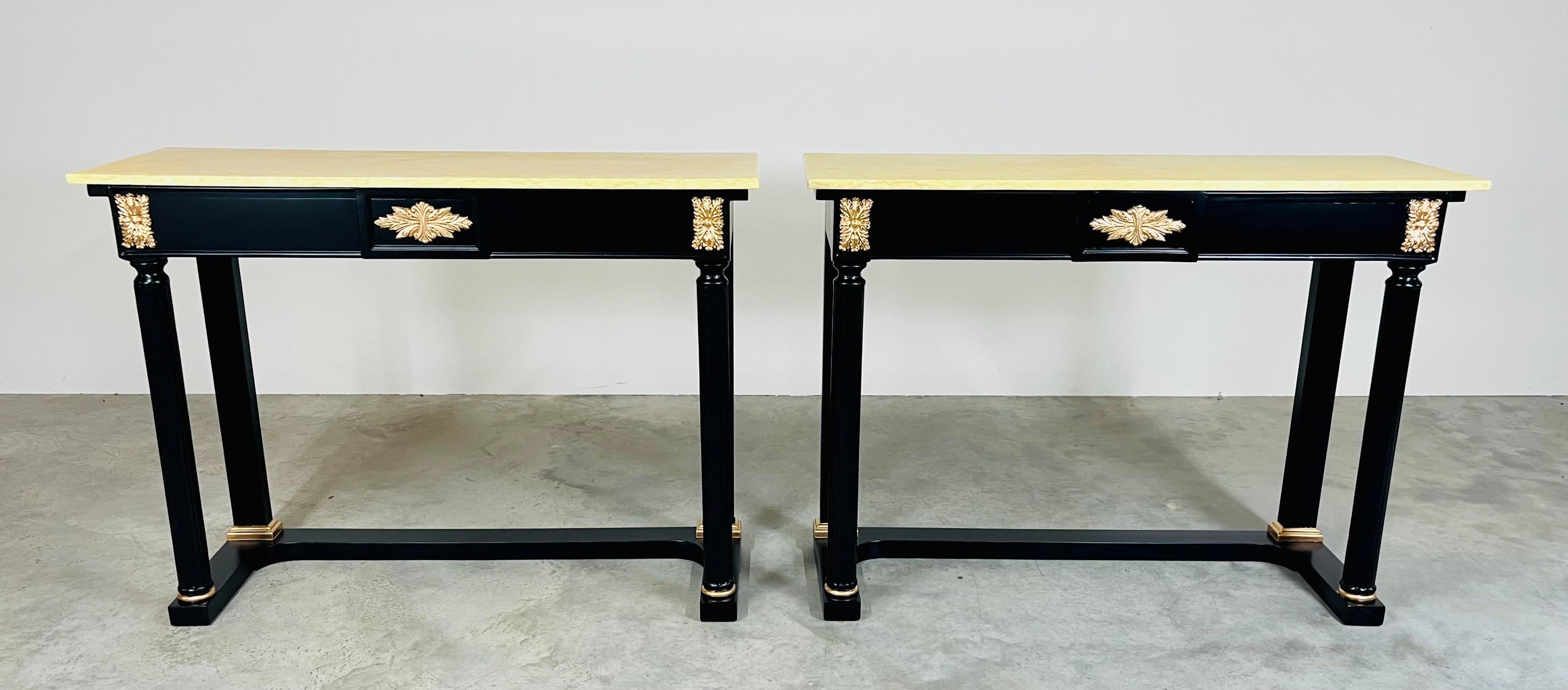 Opulent Louis XVI black lacquered console table having vintage Yellow Valencia marble tops from Spain, Louis XVI tapered legs with gold leaf accents throughout. Sold by the piece. We have 2 available. 
 In fabulous condition, made circa 1950.