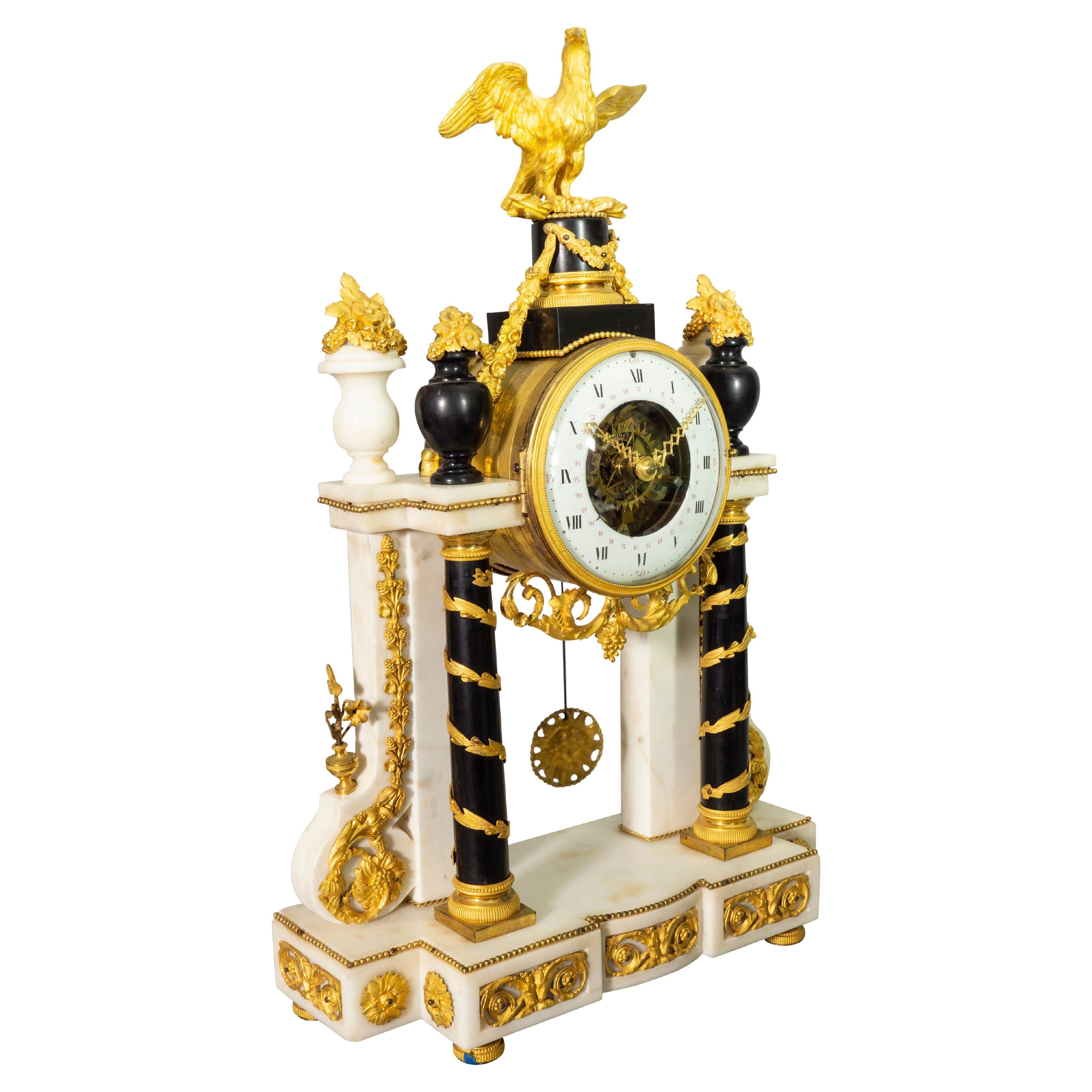 In fine condition with eagle finial over an enameled clock dial signed Degre, a fine Paris maker listed in Tardys book of French clockmakers. Flanked by two pairs of urns one white marble and the other black over marble columns wrapped in spiraling