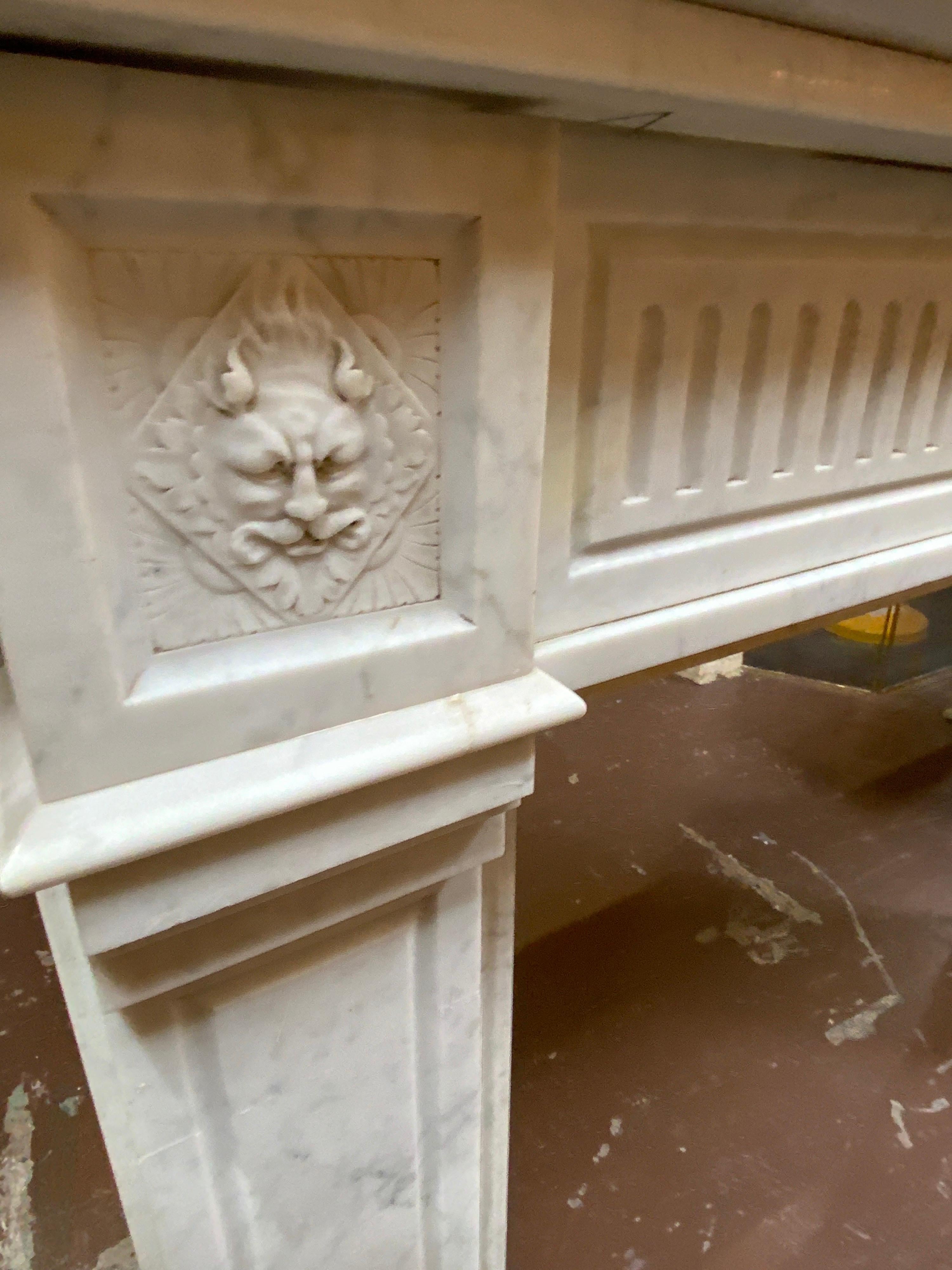 French Louis XVI Marble Mantel with Fluting and Gargoyle Motif For Sale