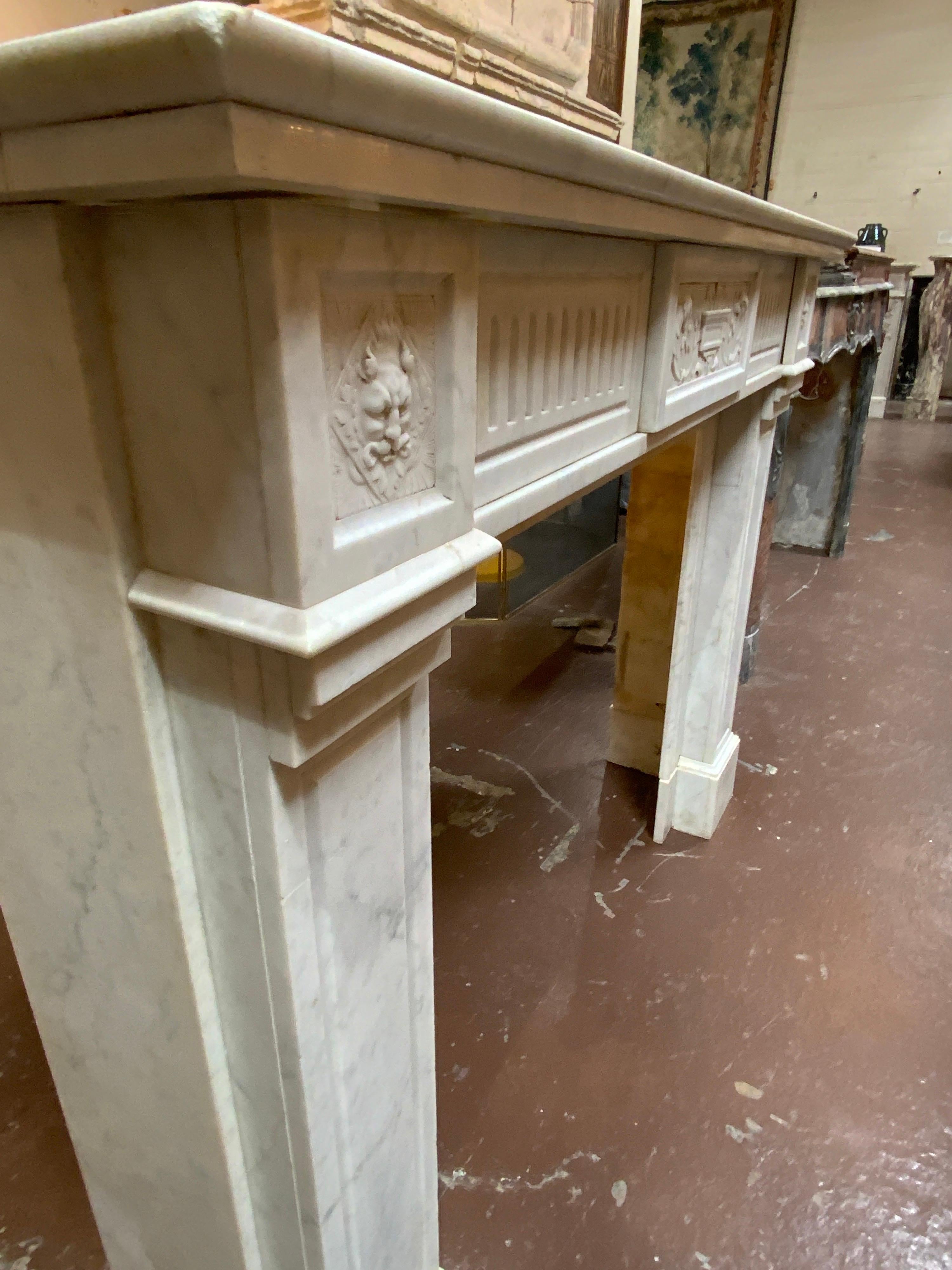 Louis XVI Marble Mantel with Fluting and Gargoyle Motif In Good Condition For Sale In Dallas, TX