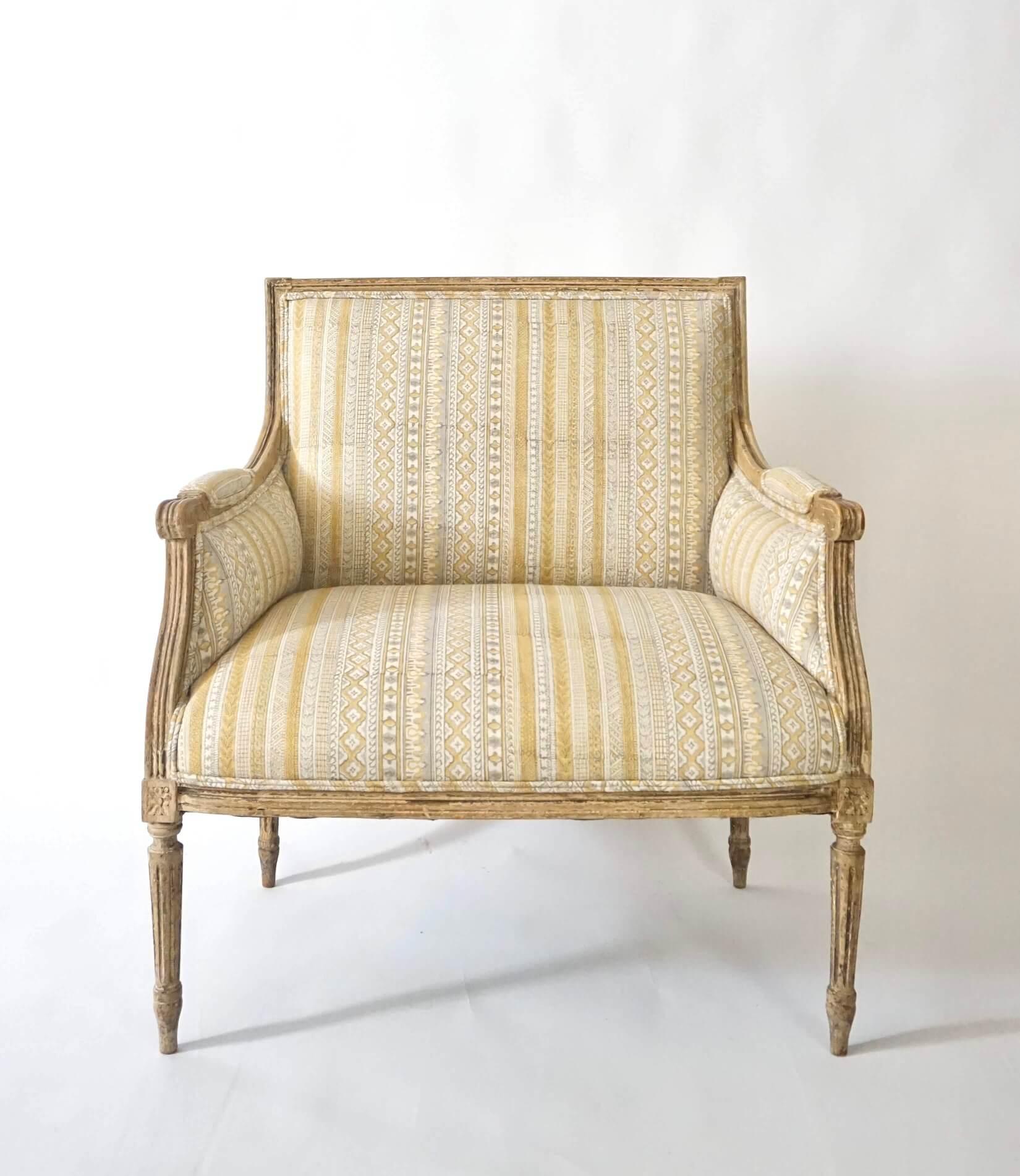 A French circa 1775 Louis XVI style 'marquise' or wide bergère in historic paint, recently upholstered in 'to-the-trade-only' G P & J Baker 