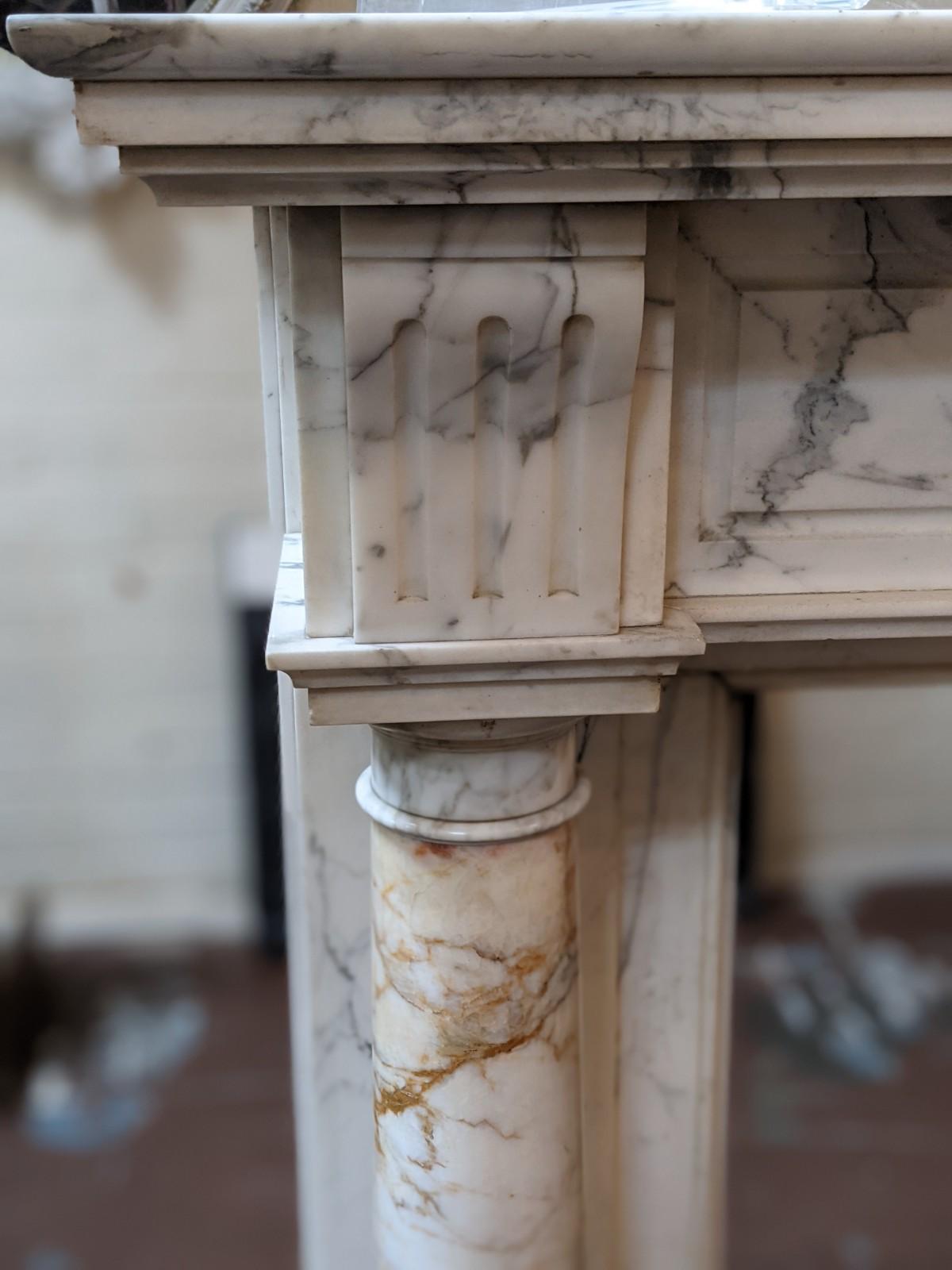 This Louis XVI multi colors marble mantel origins from France, circa 1850.

Firebox measurements: 38.5