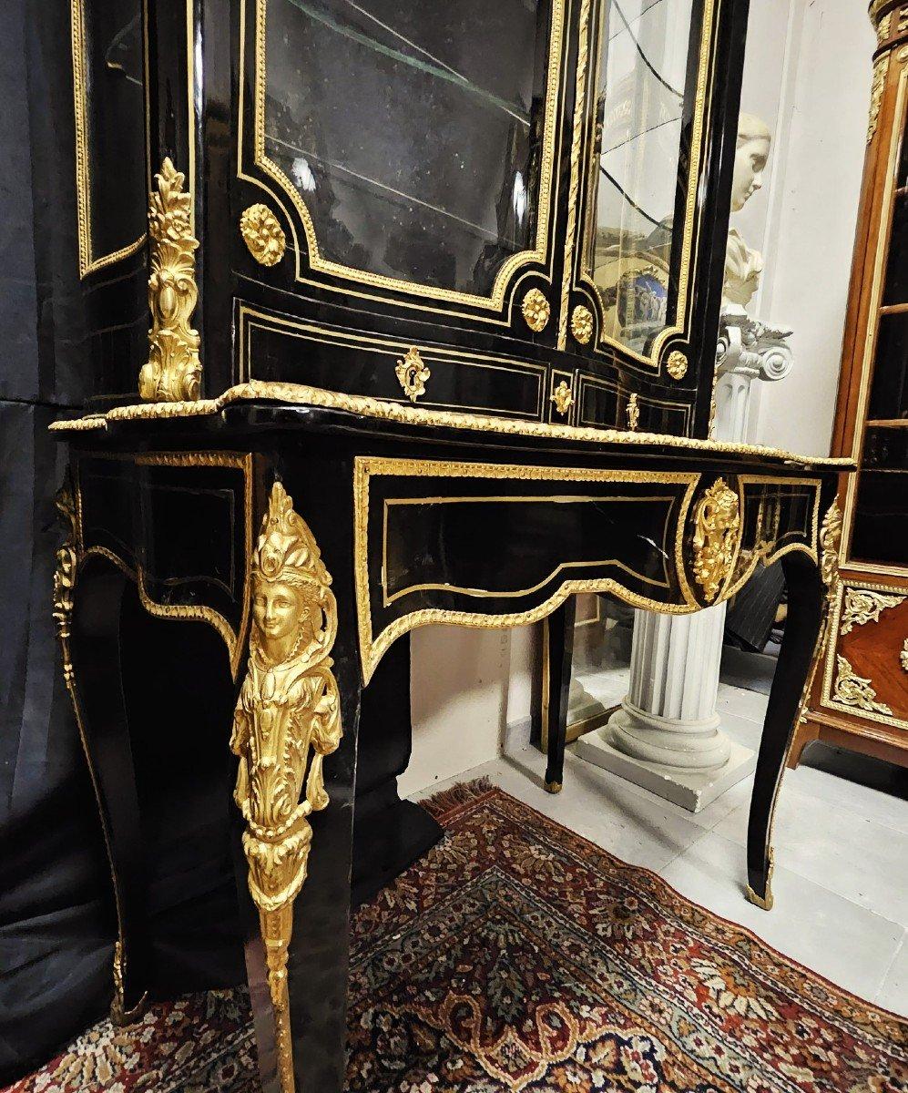 Gorgeous black desk cabinet  with a writing table, composed by two parts. The lower part is a desk table forming a writing desk with a drawer which reveals shelves adorned with gilded leather with a small iron, and a storage space below. The upper