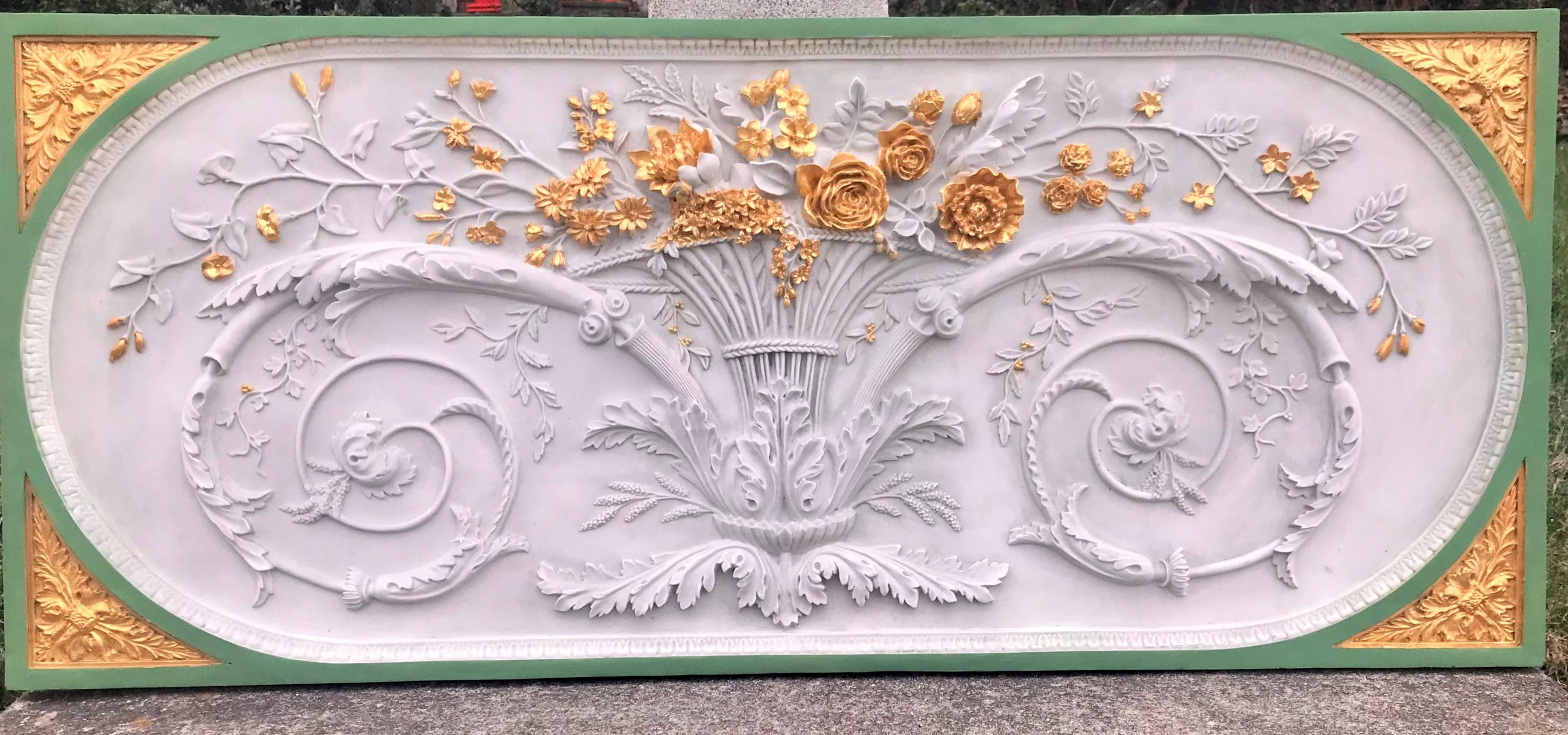 A grand floral design with neoclassical design elements on panel . The flowers gilded in gold leaf the overall border in French Green (possibly later added ). Of an unknown composite material with an up-close look of marble or polished plaster.