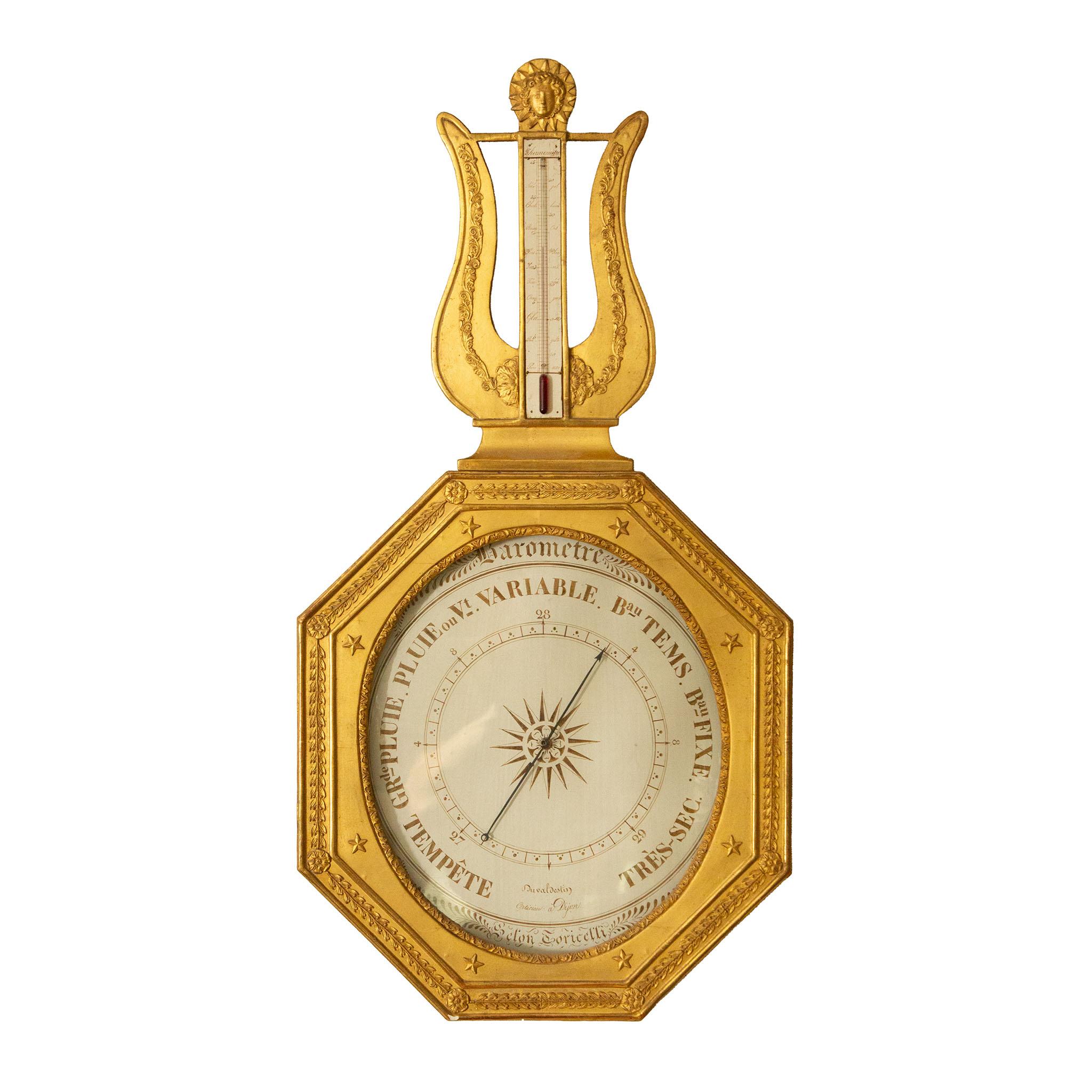 Louis XVI Giltwood Barometer-Thermometer, French, late 18th Century, made by Duvaldestin in Dijon, France
Elegantly carved from limewood and water-gilt in burnished and matte gold, this octagonal wall barometer is surmounted by a lyre-shaped crest