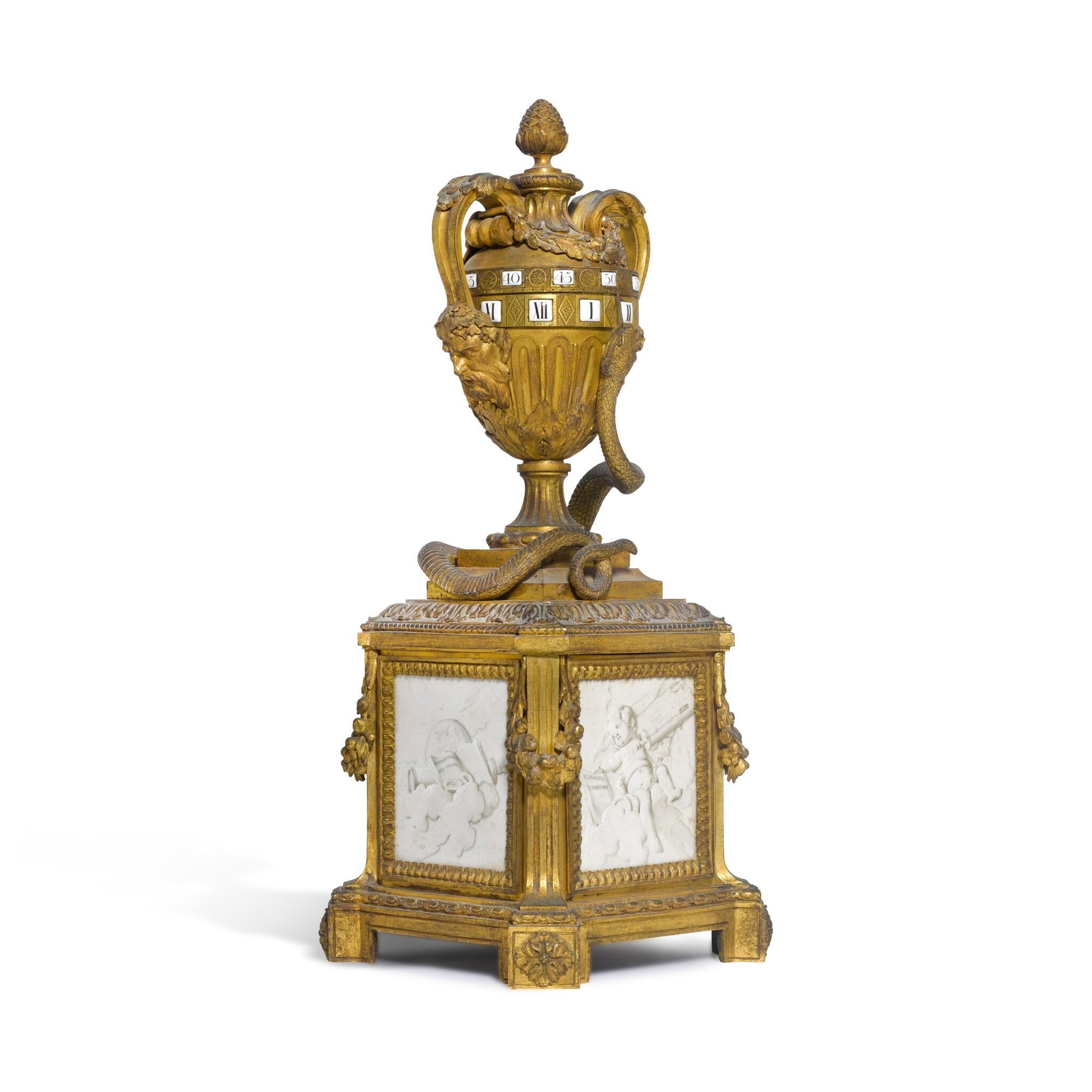 This exquisite Louis XVI table clock showcases the neoclassical elegance of its time, crafted by renowned clockmaker Antoine Crosnier in Paris around 1780. The clock features a striking urn shape adorned with mask handles, embodying the refined