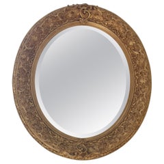 Antique Louis XVI oval mirror in gilded wood and stucco from the 19th century