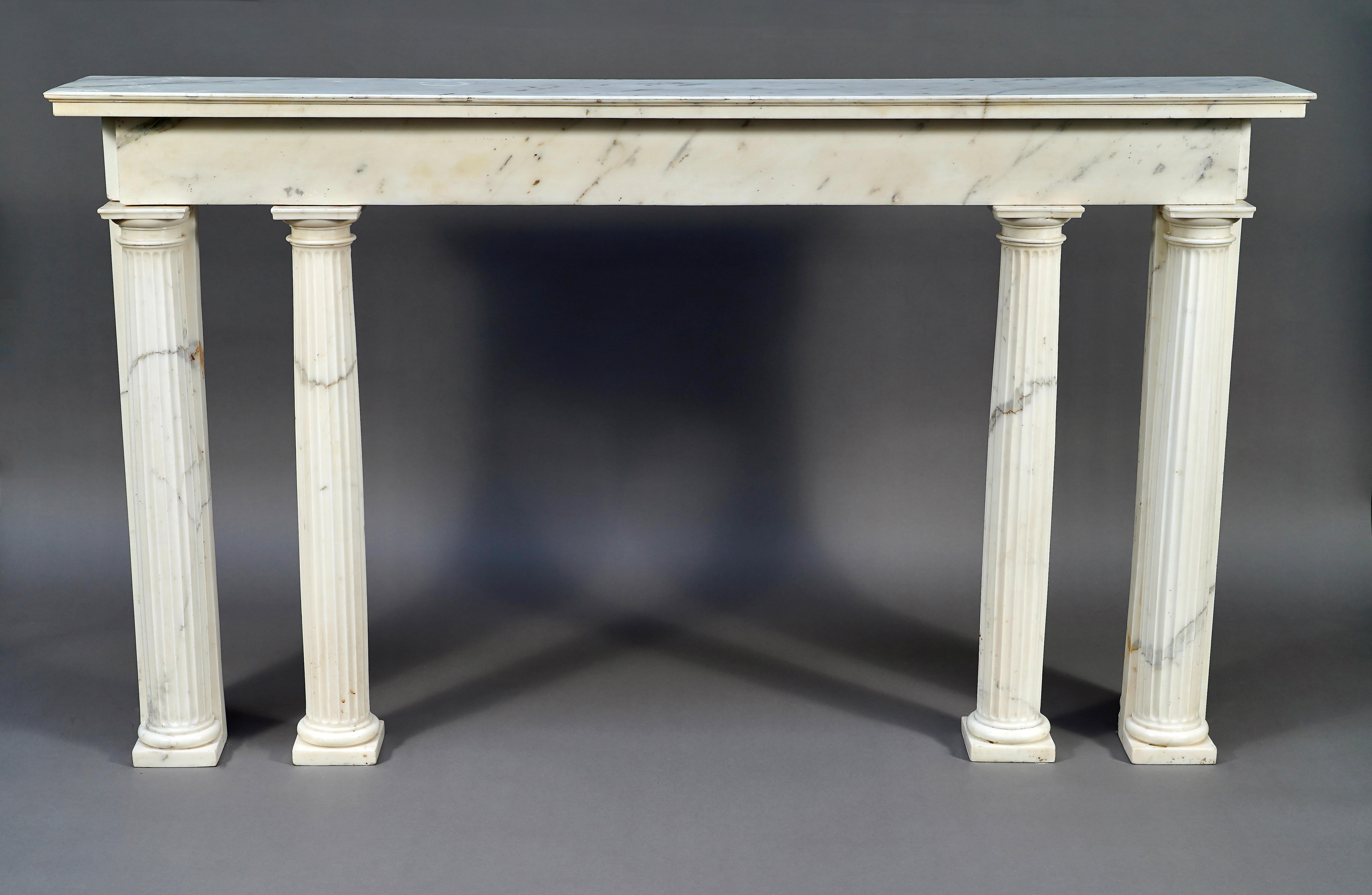 Rare neo-classical Louis XVI period console sculpted in white Carrara marble. The rectangular lintel, surmounted with a molded top, is supported by four detached fluted columns with Doric capitals.

The straight lines and refined style of this