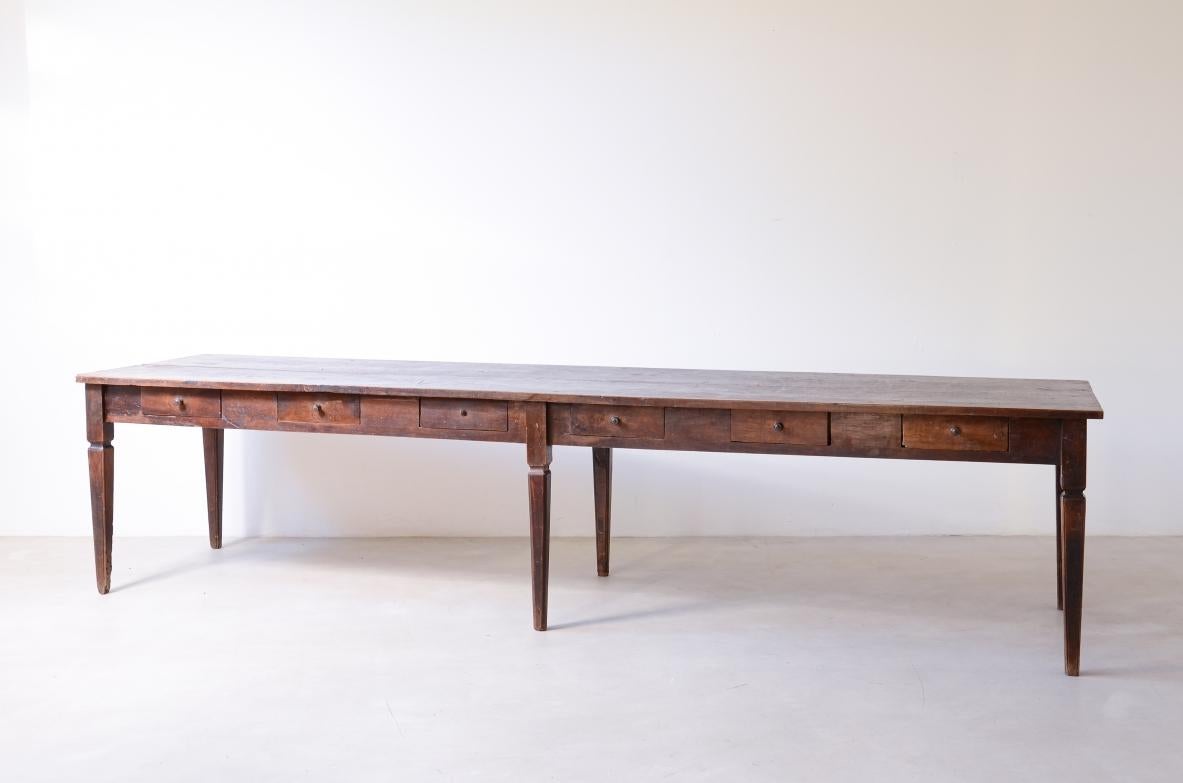 Extraordinary large walnut table in perfect patina with six drawers and six elegant pyramidal legs.

Italian Neoclassicism, Tuscany, Louis XVI period, ca. 1790.

Restoration required.

