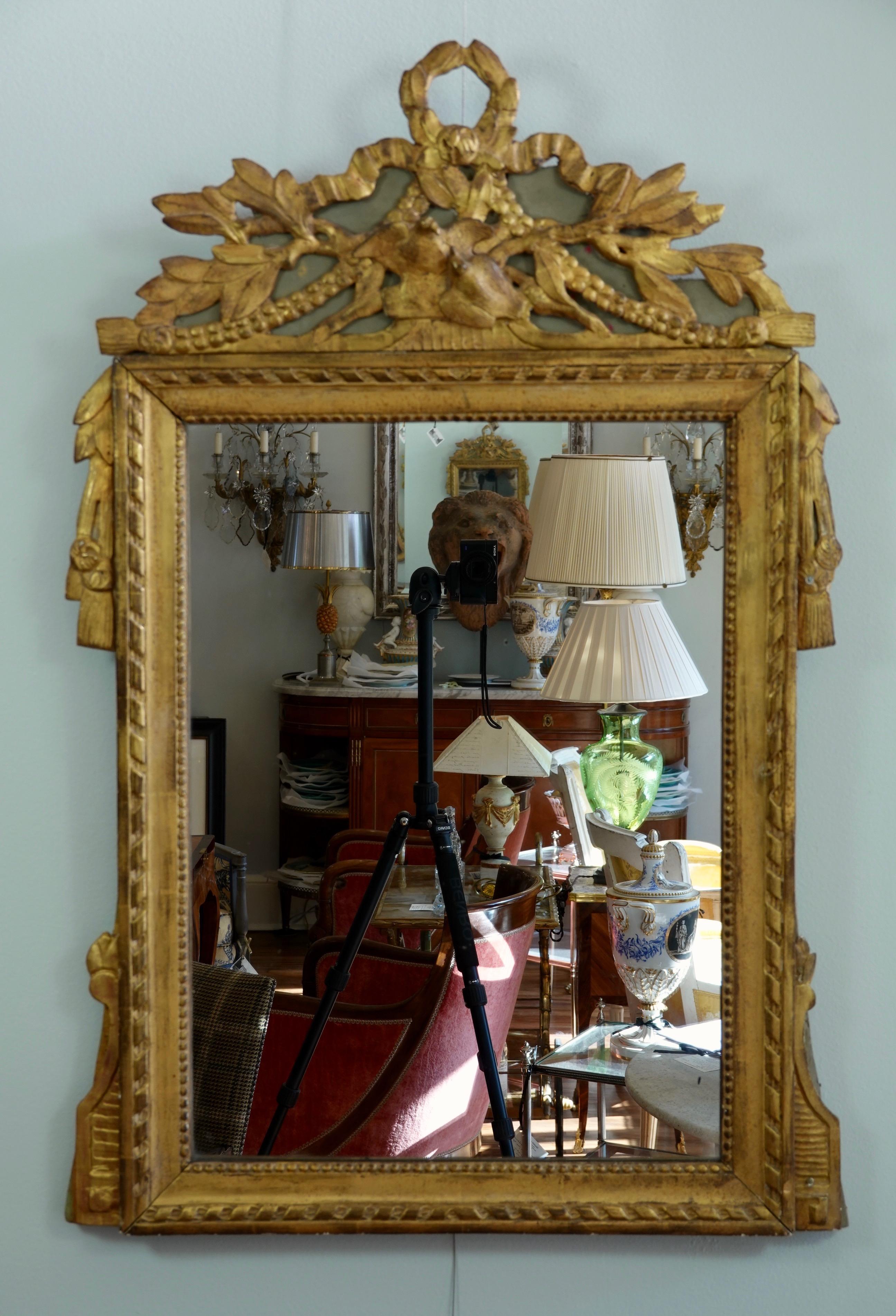 Very charming, French, Louis XVI period parcel gilt and painted marriage Trumeau mirror, featuring two birds kissing on the pediment. Other neoclassical ornaments include a laurel wreath and leaves, ribbon, swags, tassels and pearl beading. Wooden