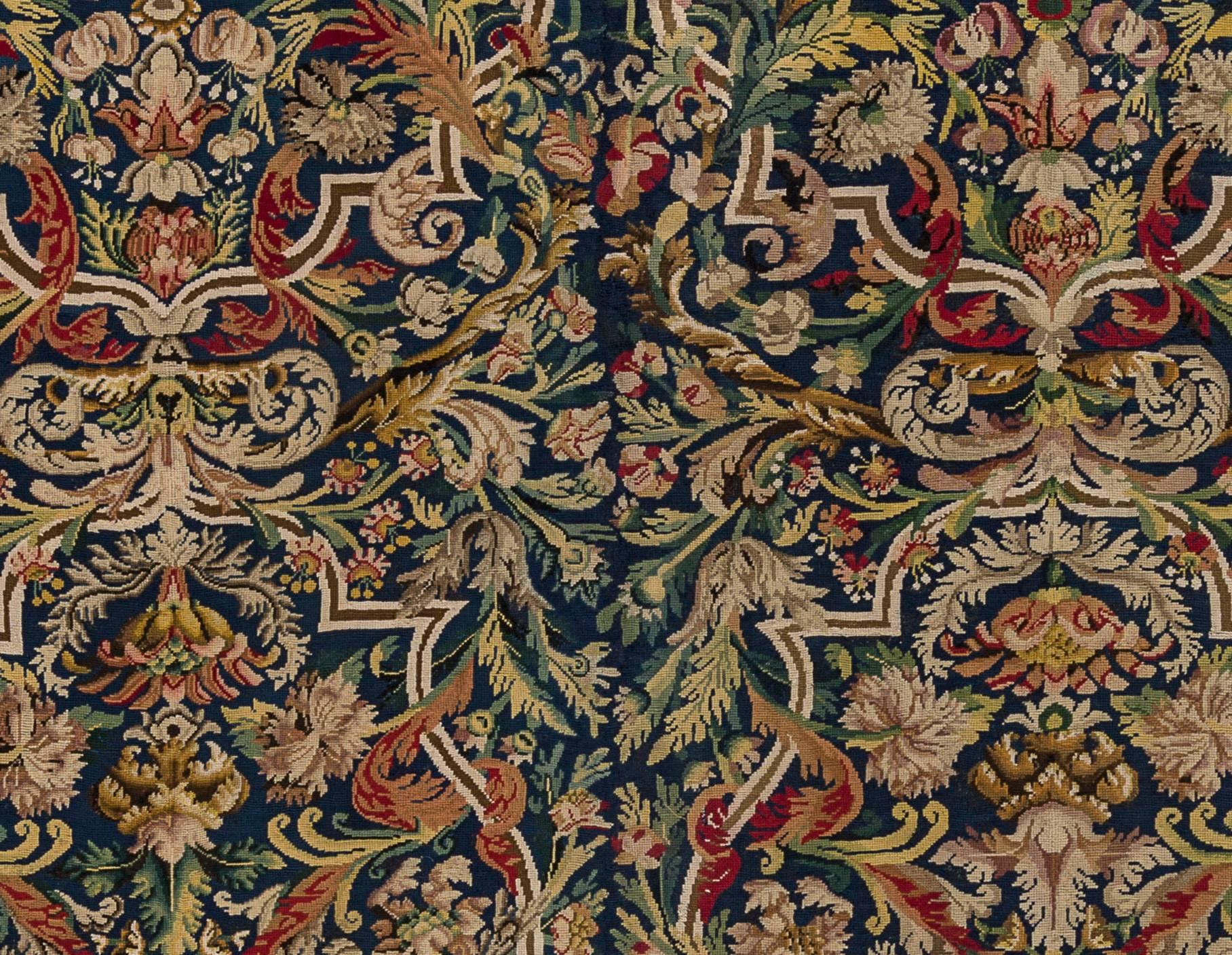 Elegant needlepoint carpet
France, Louis XIV period (Late 17th - early 18th century)
Silk and wool.

On a black background, typical Louis XIV design made of interlacing and garlands of flowers. Thin border with a garland of flowers.