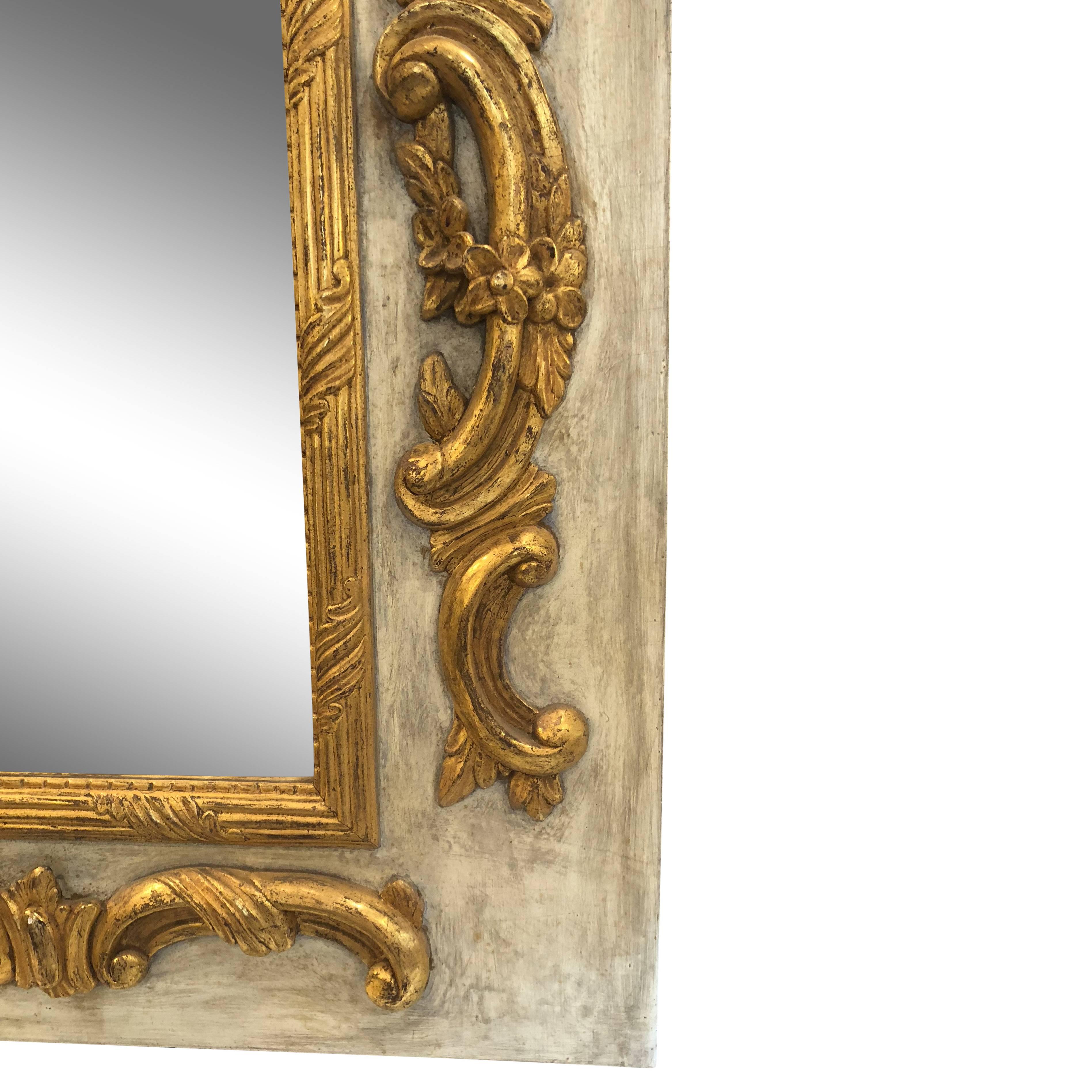 Louis XVI period mirror with intricate gold carved and gilded wood. Mirror has a beautiful antiqued finish.