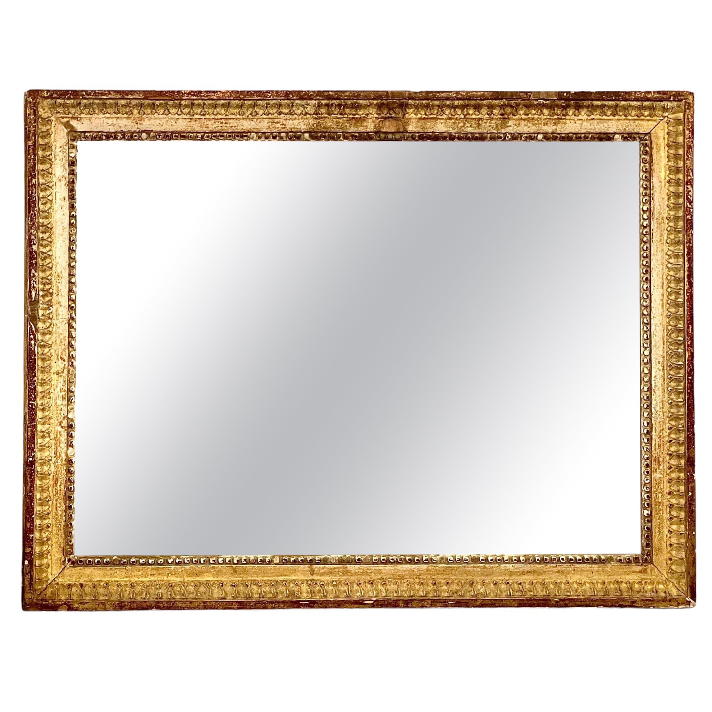 Miroir rectangulaire en bois doré d'époque Louis XVI en vente