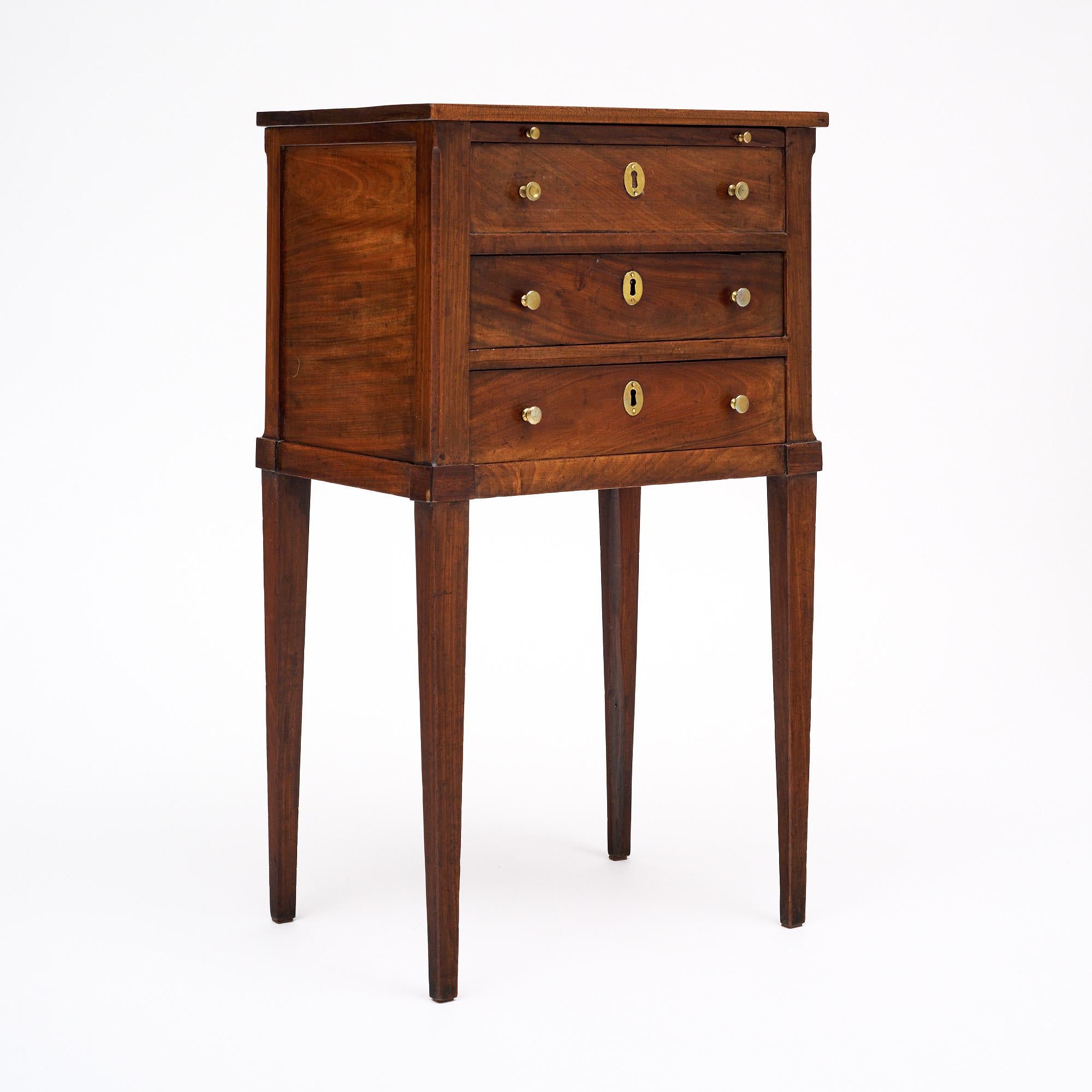 Side table in the Louis XVI period  from France. This lovely table is made of solid wood construction; primarily Elm wood. It has been finished with a lustrous French polish of museum quality. There are three dovetailed drawers below one pull-out