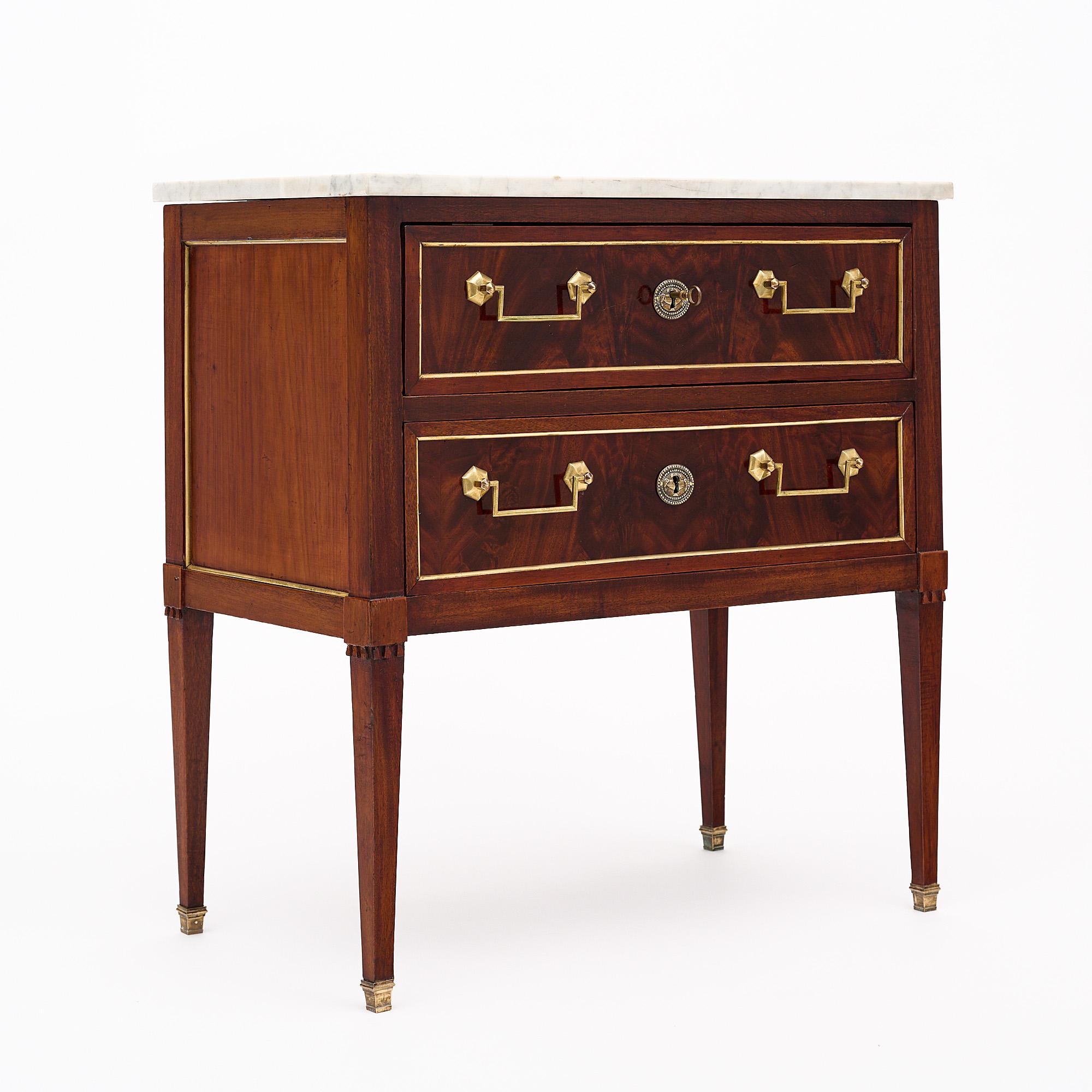 French antique chest of drawers, styled after the elegant Louis XVI era. Crafted from cherrywood and adorned with burled cherrywood, its two dovetailed drawers exude sophistication, complemented by luxurious gilt bronze hardware. Delicate