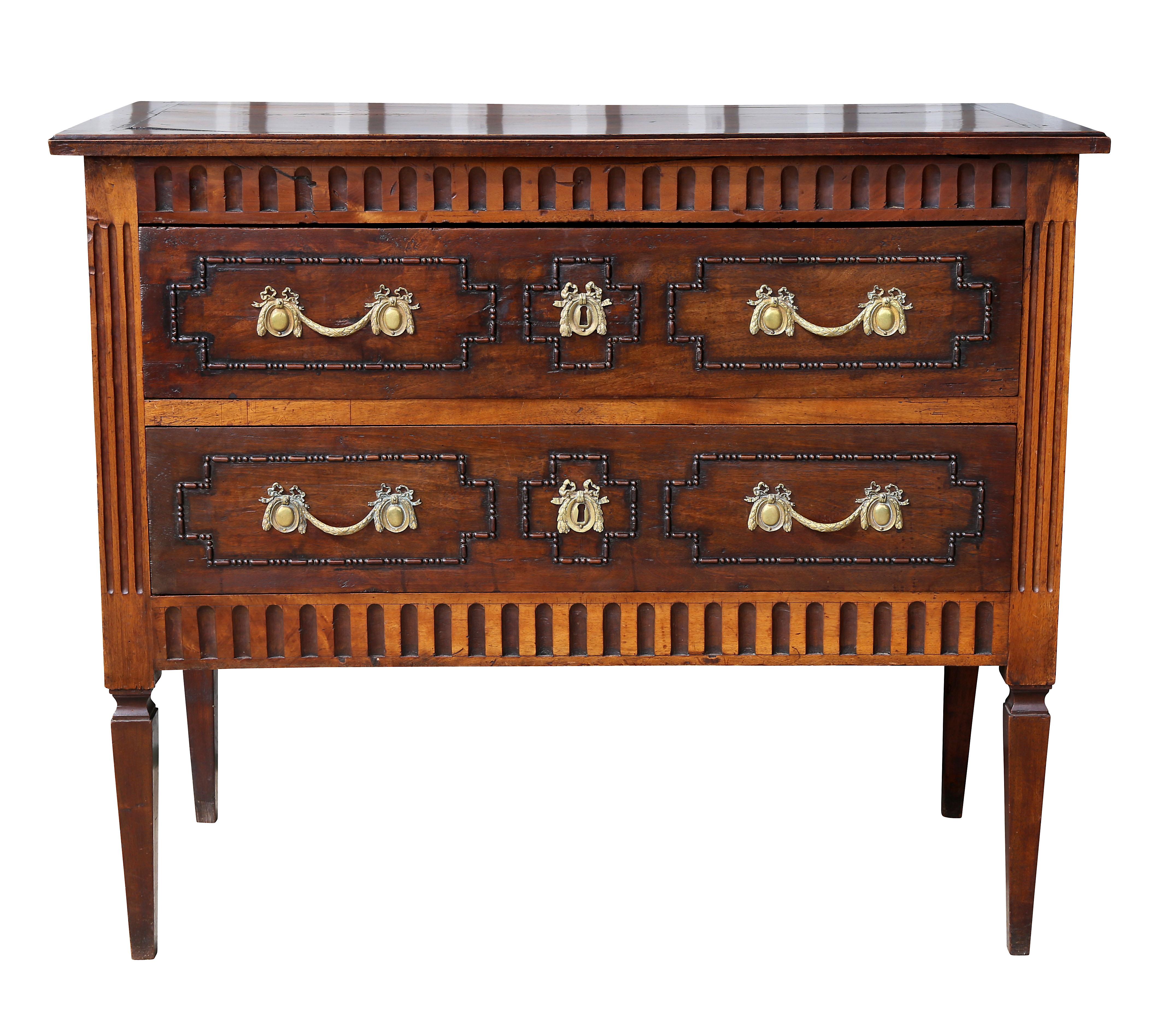 With rectangular top over two drawers with carved beaded decoration and fluting between drawers, raised on square tapered legs.