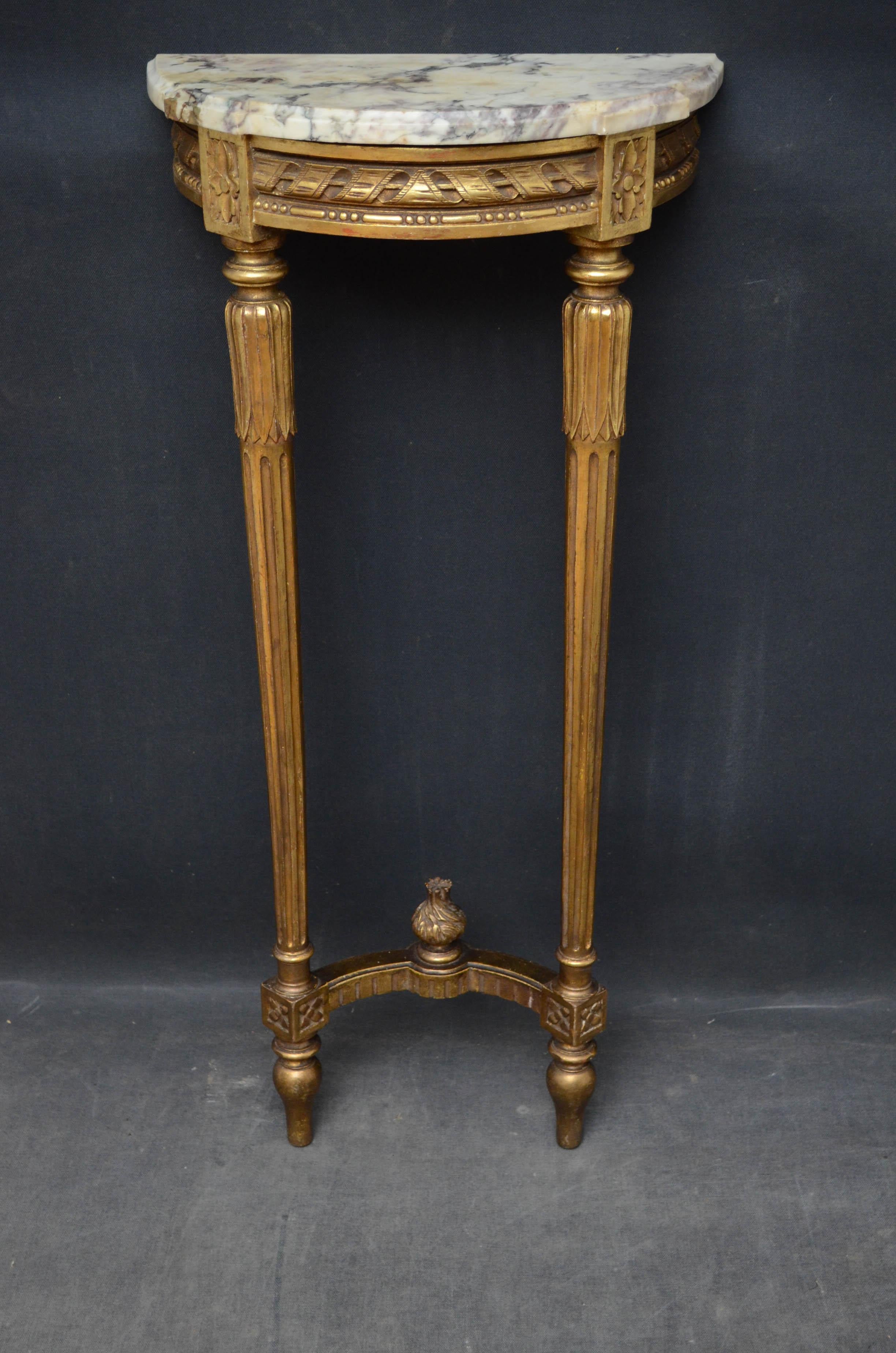 Sn4551 French gilded half moon hall table, having original veined marble top above carved frieze, standing on slender carved and reeded legs united by a stretcher. Retains original gilt, circa 1900
Measures: H 35