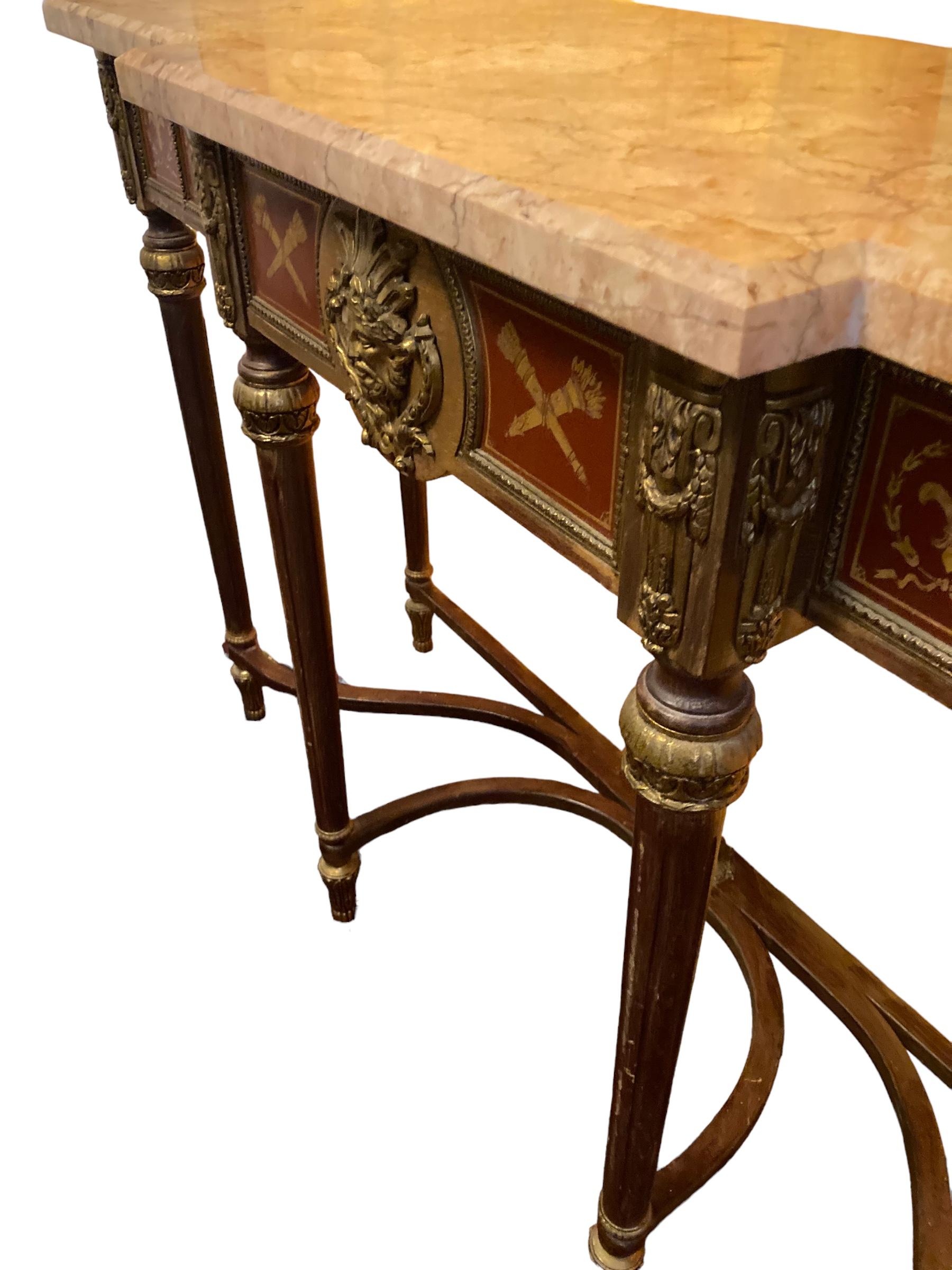 Louis XVI Revival Style Console Table by H & L Epstein, solid marble top, cast gilt bronze  mounts and feet with decorative bronze head on the single drawer with painted gilt Fleur de lys either side. Serpentine stretchers with central gilt metal