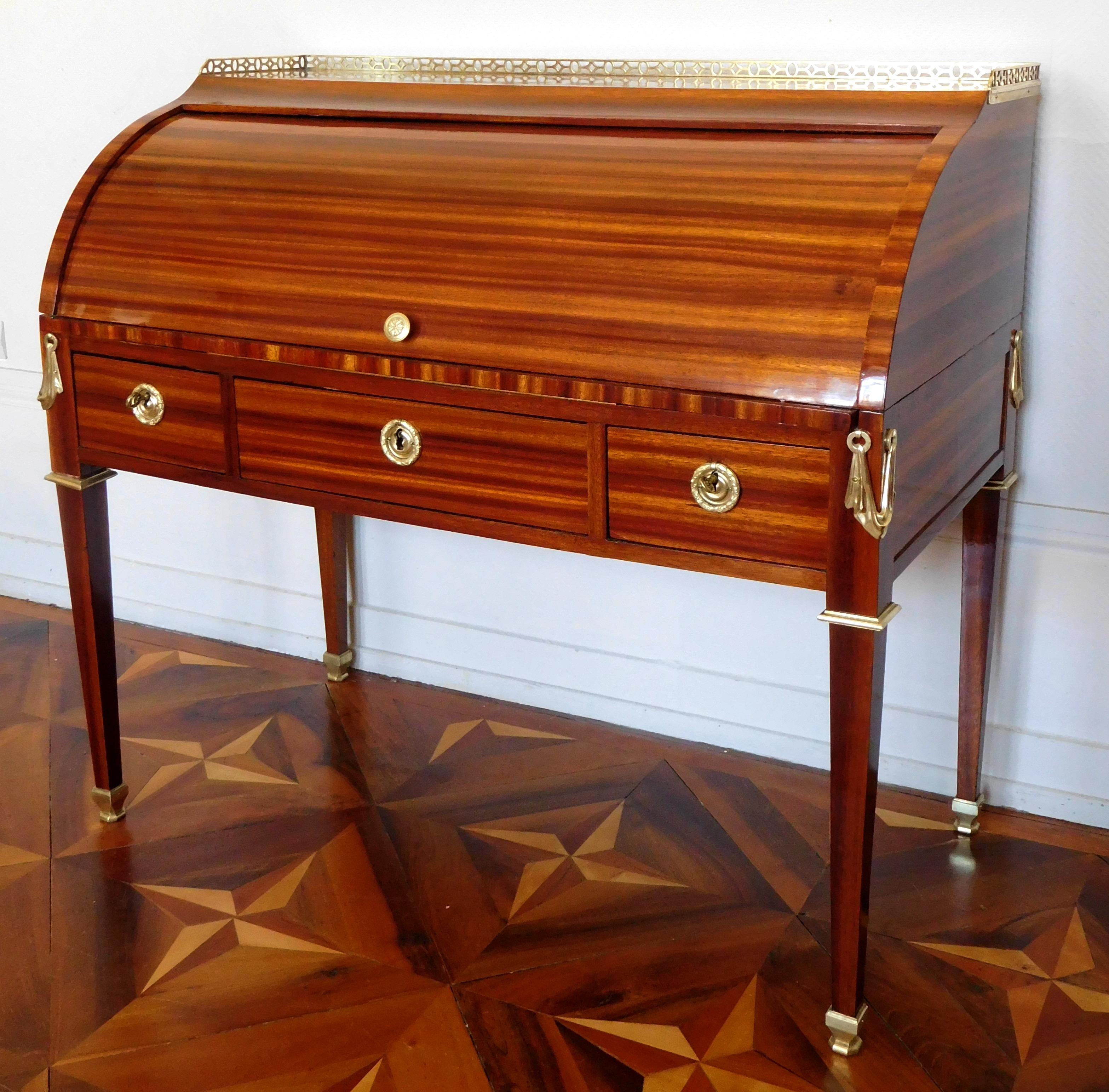 Louis XVI mahogany roll top desk, ormolu ornamentation, France, late 18th century, circa 1780.

Roll top desks were created at the end of Louis XV reign ; they are mechanical pieces of furniture, which allows - once closed - to keep the work