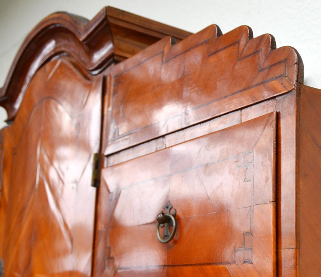 Louis XVI secretary, Germany, 1790s. Made of cherrywood and other fine woods. 

Turned feet, chest of drawers with three drawers with thread and ribbon marquetry all around, above the chest of drawers an inclined writing plate behind which there