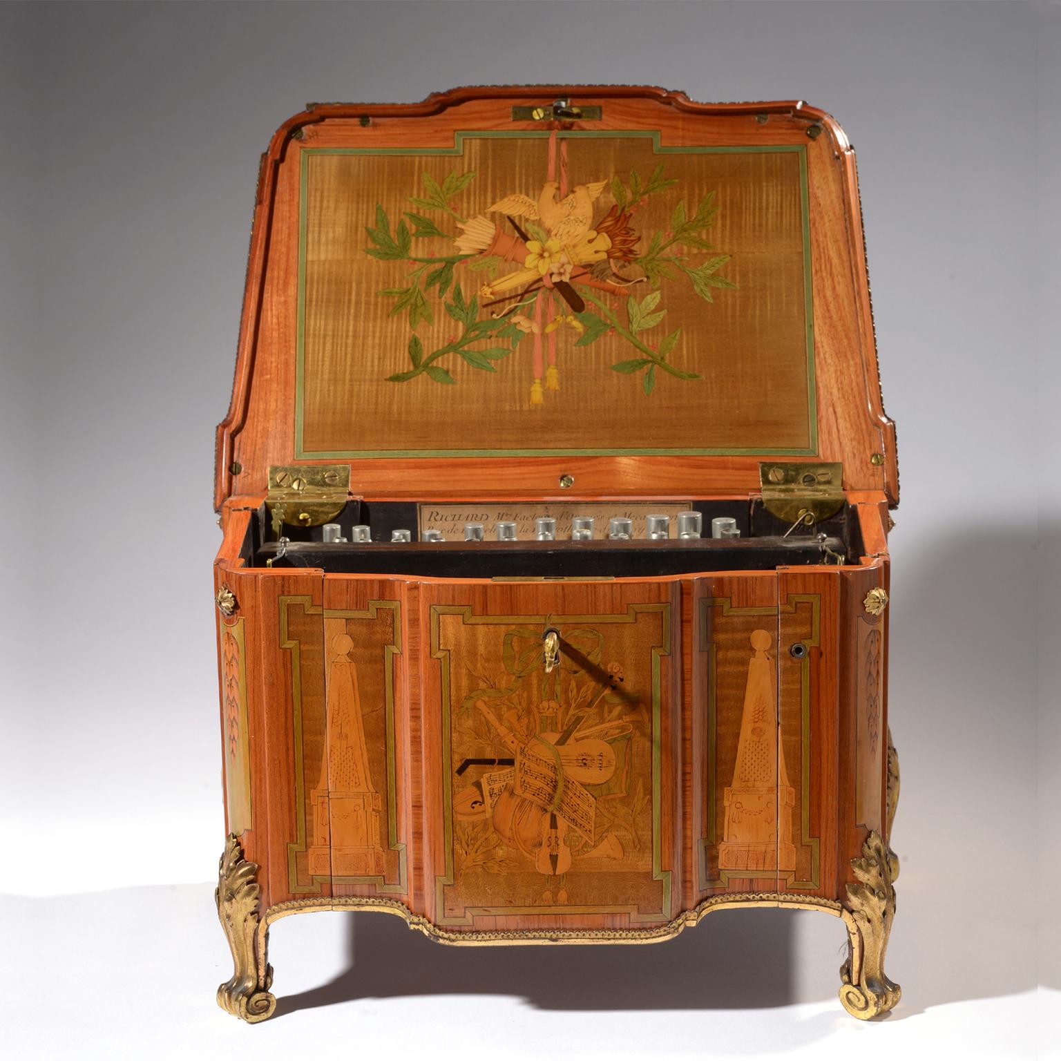 A very rare Louis XVI period serinette or bird organ in the form of a transitional style gilt bronze mounted and marquetry inlaid miniature commode in the manner of gilbert, by Robert Richard, Paris.

With a label for ' RICHARD - maitre facteur