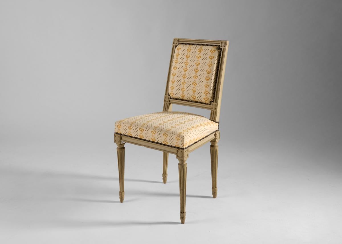 Dieser charmante Louis XVI-Beistellstuhl besitzt eine bemerkenswerte Festigkeit für ein Stück seiner Größe. Er ist aus handgeschnitztem, lackiertem Holz gefertigt und mit eleganten Linien und Messingdetails versehen, die die gepolsterten Kissen