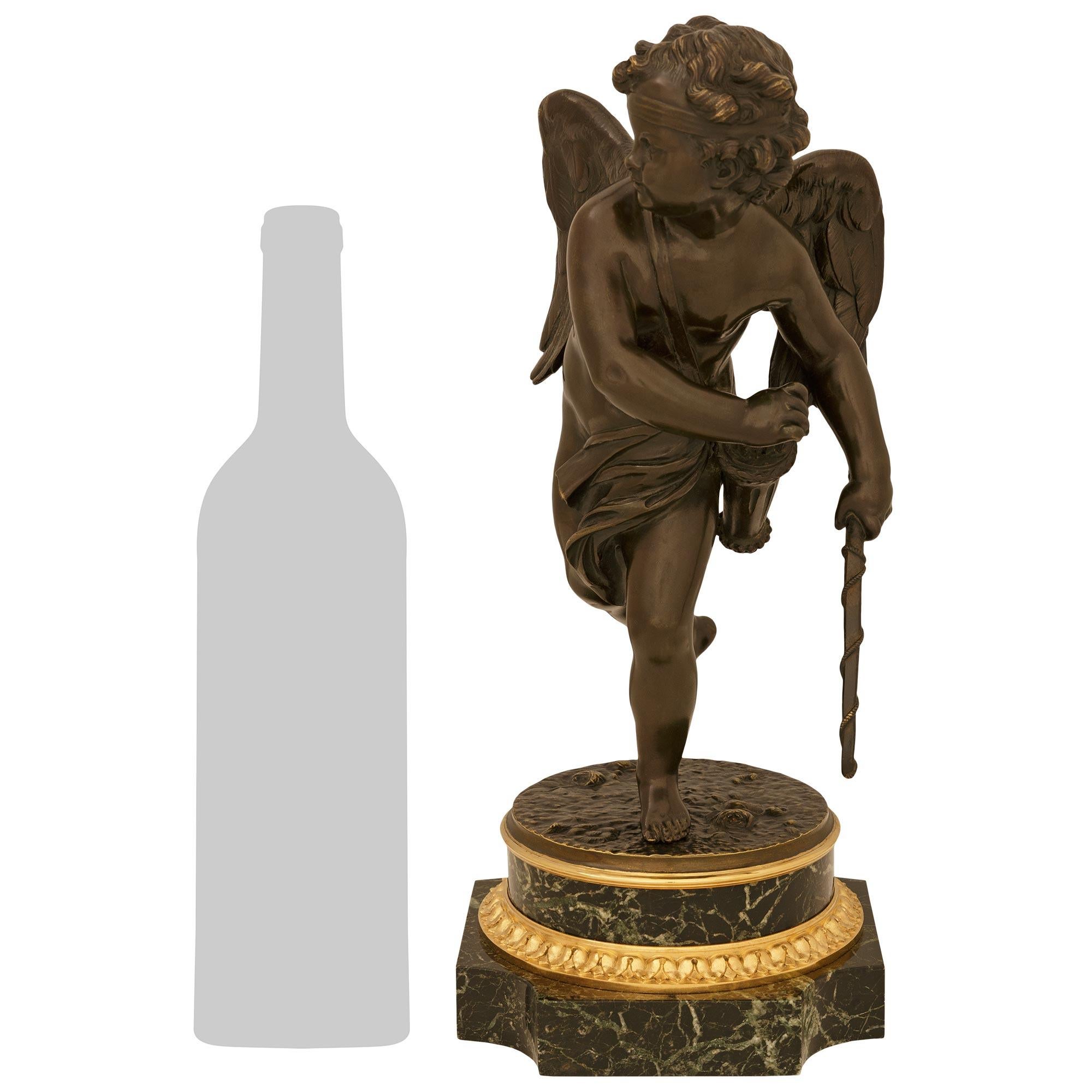 A charming and high quality French 19th century Louis XVI st. patinated Bronze, Ormolu and Vert Antique marble statue. This wonderful statue of an open winged cherub is raised by a square Vert Antique marble base with concave corners below a Rais de