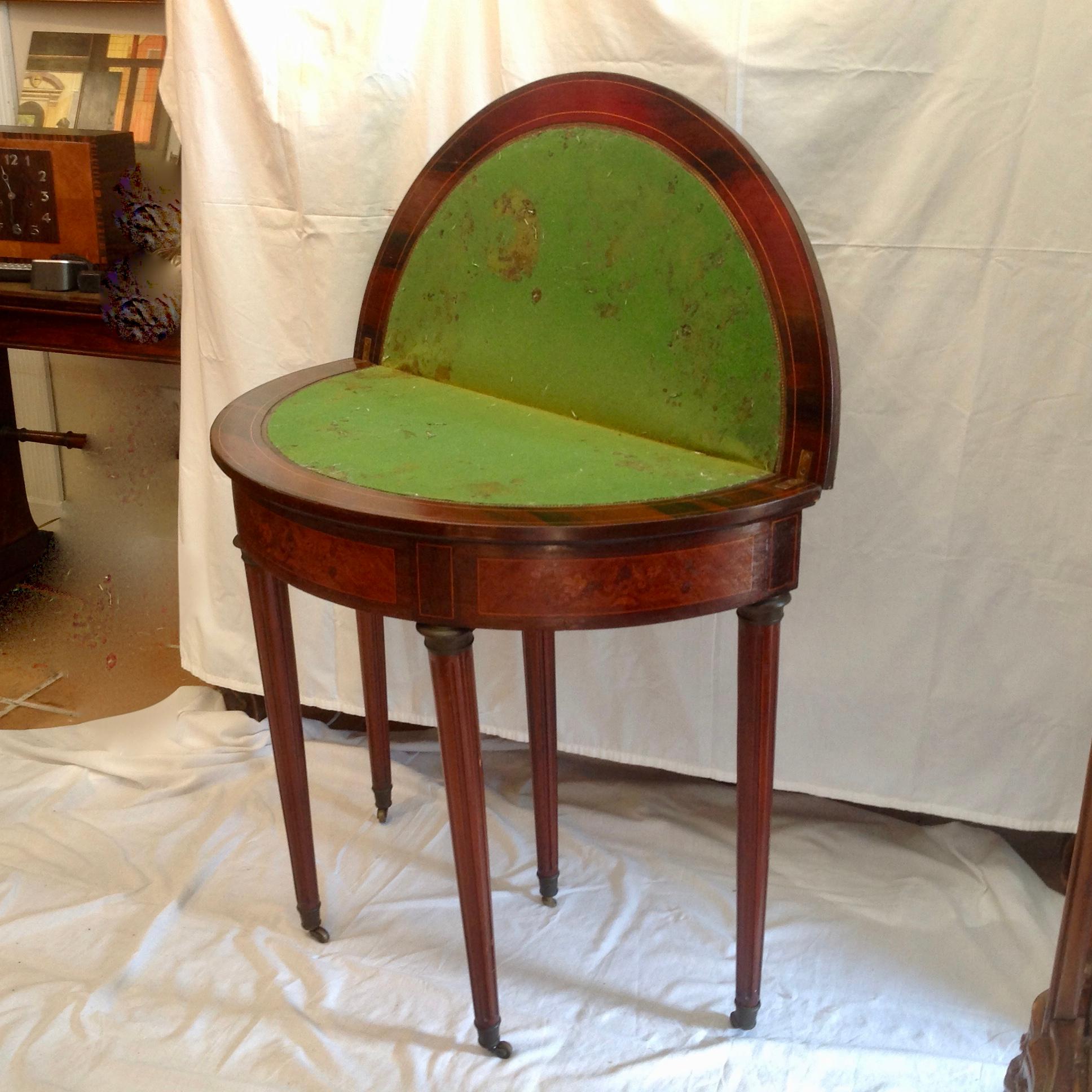 This is a very nice Louis XVI style demilune, with satinwood marquetry, flip top game table.
Having a well-worn green baize playing surface. The table is raised upon fine turned legs with brass castors, brass to the top of the legs, and also the