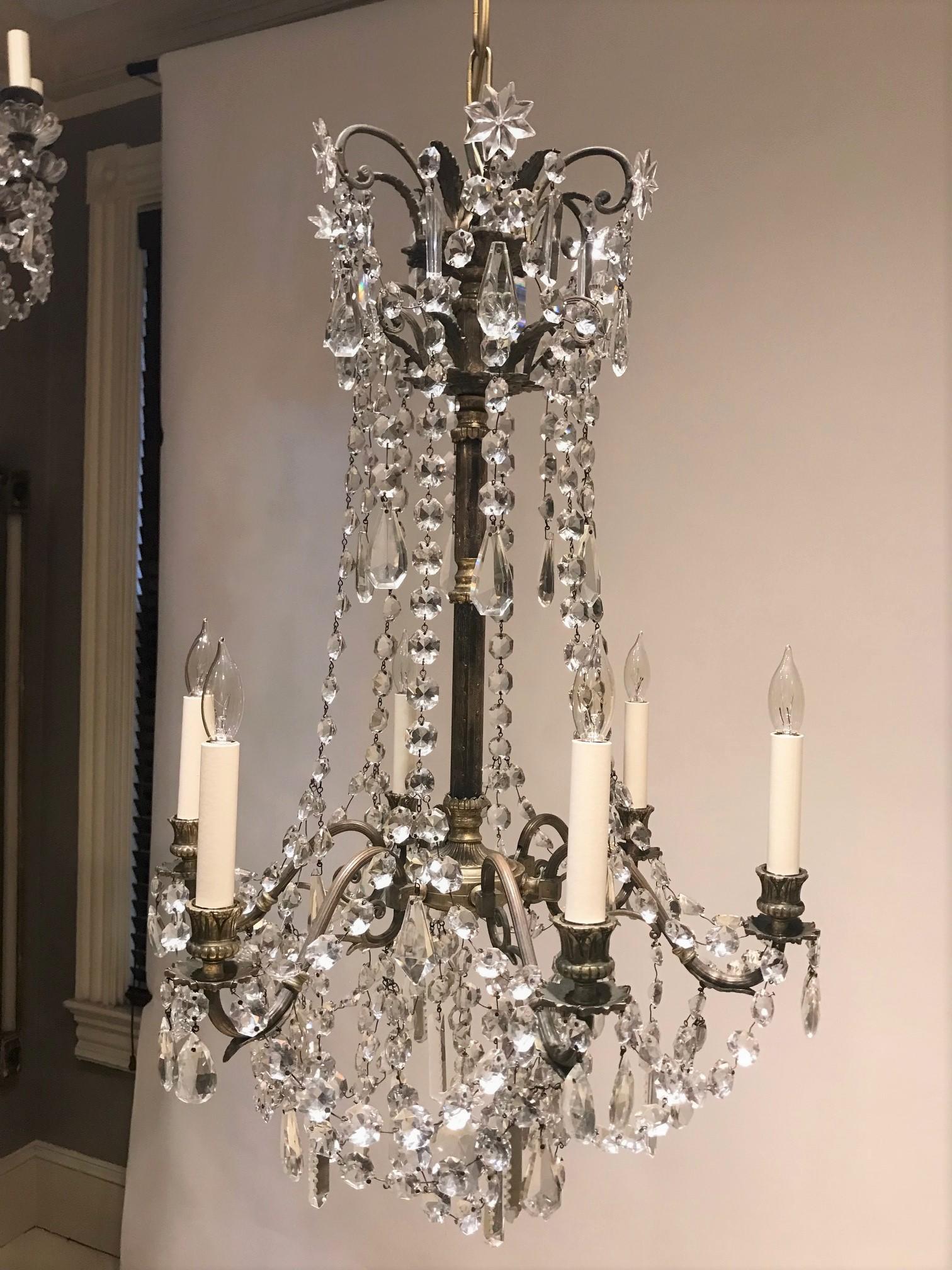 This beautiful chandelier was made during the reign of Napoleon III in the style of Louis XVI, probably at an atelier in the suburbs of Paris. The frame is hand-crafted gilt bronze with original hand-cut lead crystal. The fixture was originally a 6