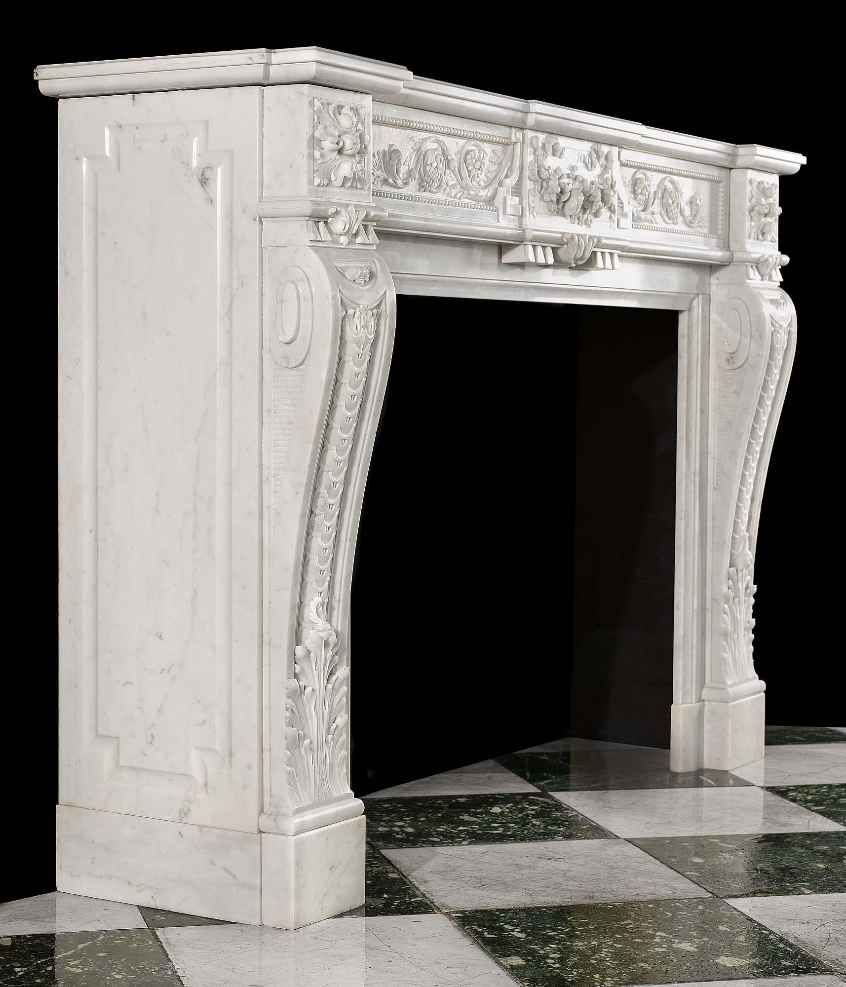 A fine Louis XVI style antique chimneypiece in Carrara marble, the frieze centred by a plaque in high relief that is deftly carved with a garland of summer flowers gathered by ribbons from which emanates an abundance of scrolled foliage punctuated
