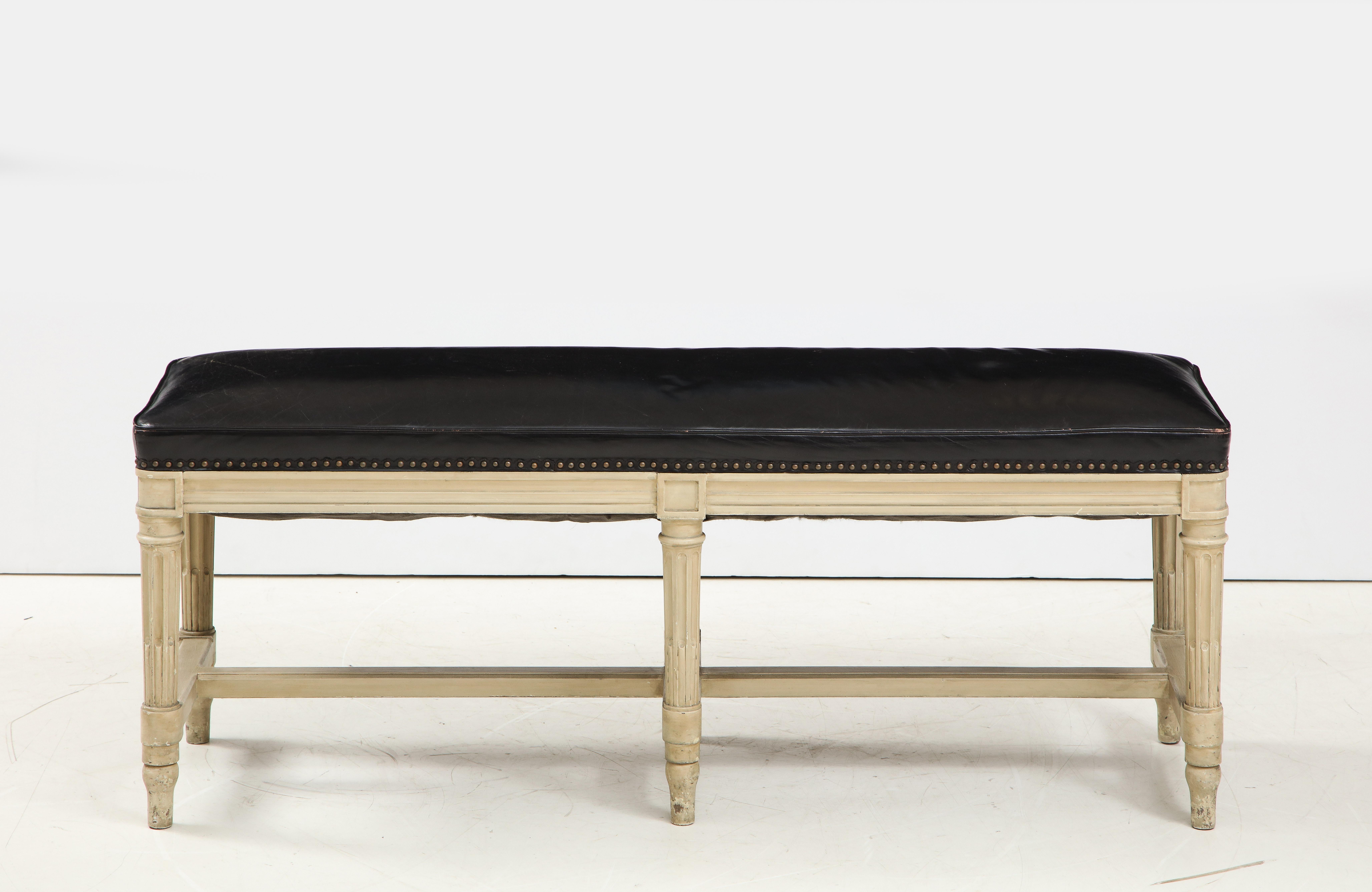 Louis XVI style beechwood bench upholstered with black leather studded seat.
 