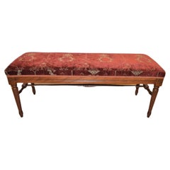 Louis XVI style bench upholstered with a red antique chenille fabric.