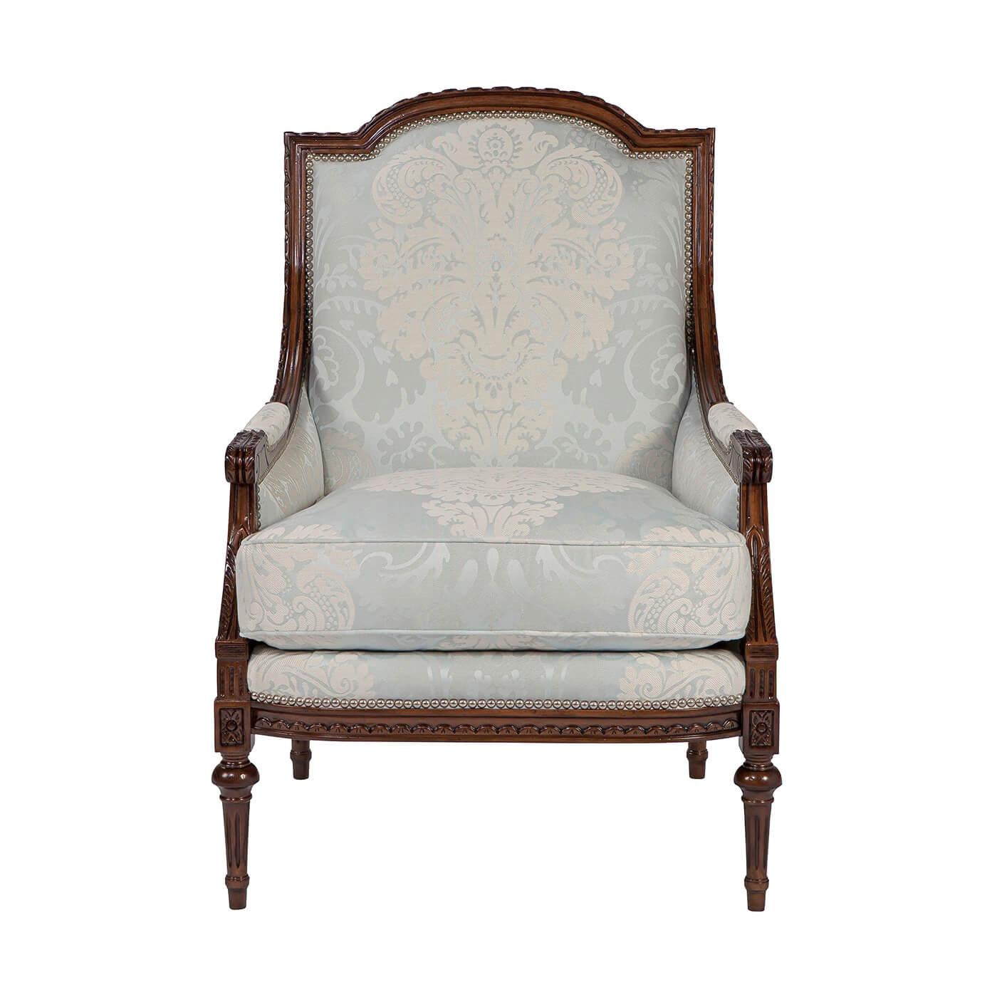A finely carved fauteuil, the paper twist carved, arched top rail and down swept padded arms with scroll terminals enclosing an upholstered back and cushion seat with close nailed decoration, on a finely carved seat rail with flowerhead capitals to