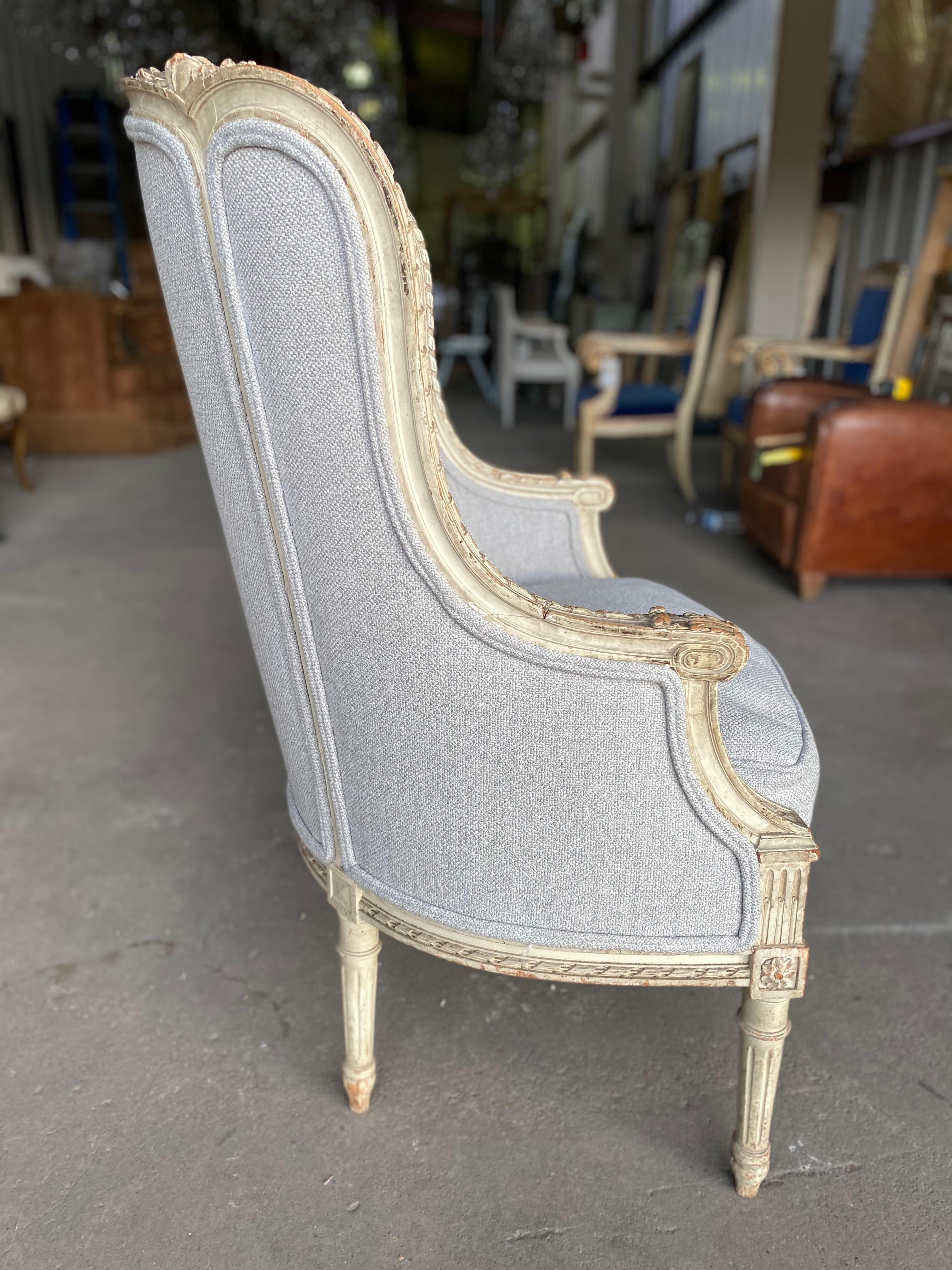 Antique Louis XVI style wood bergere armchair with a down filled seat. Beautiful and recently upholstered. Perfect for any design space. Reupholster to your liking or keep as is.